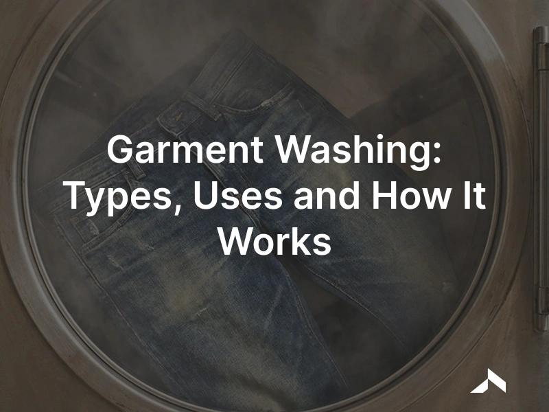 Garment washing: finished denim jeans tumbling in an industrial washing machine for a faded, softened wash finish