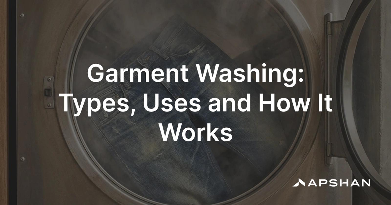 Garment washing: finished denim jeans tumbling in an industrial washing machine for a faded, softened wash finish