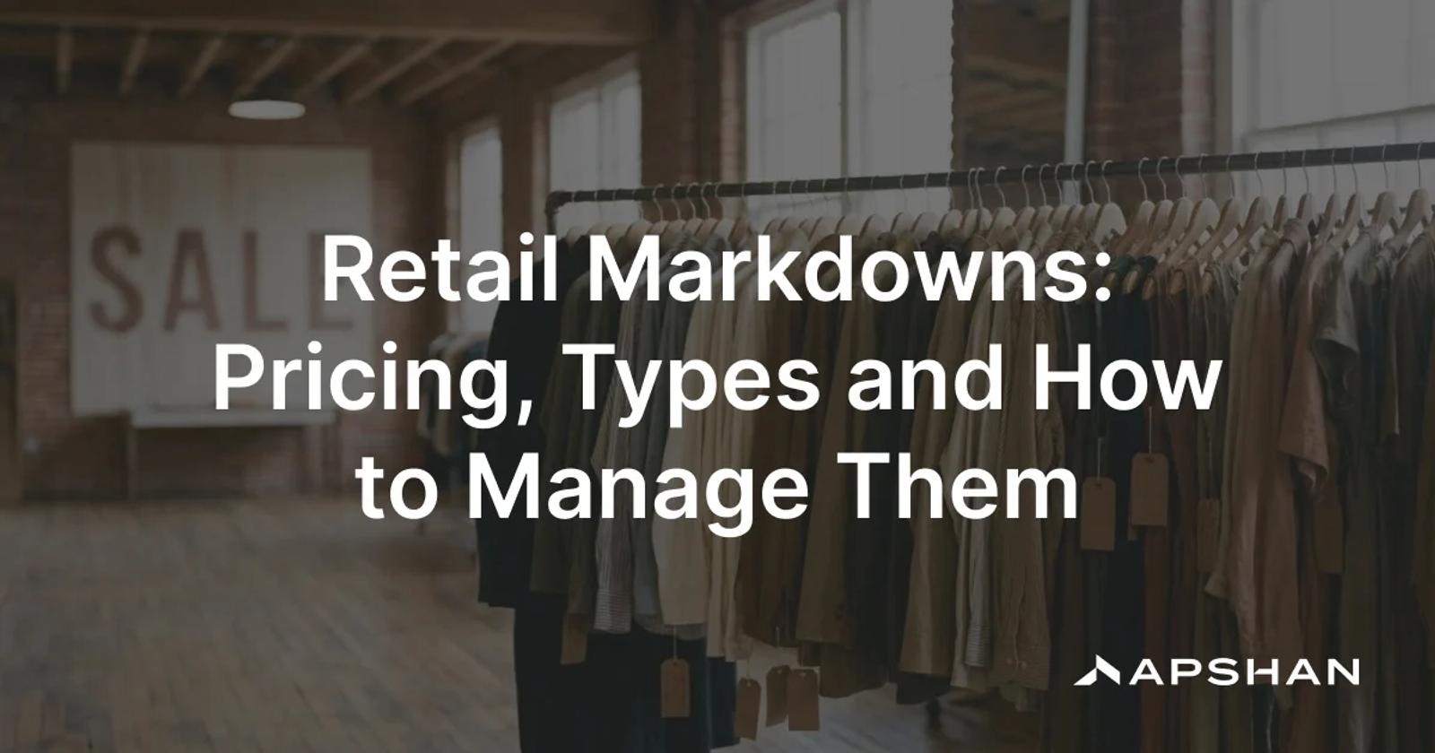 A clothing rail with reduced-price tags in a retail store, a sale sign softly out of focus behind it