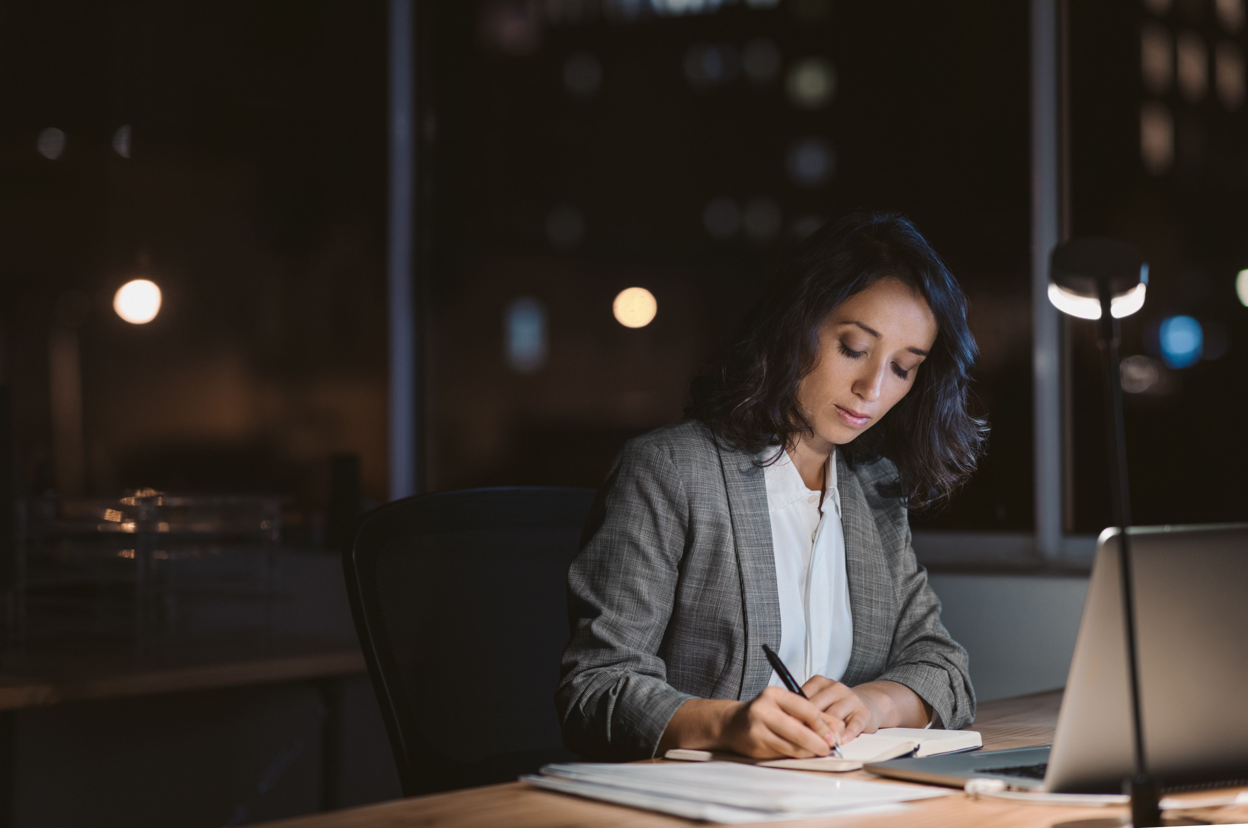 woman working late at night in office