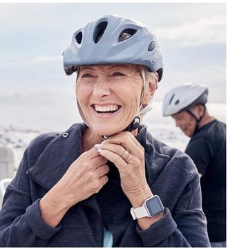Woman putting helmet on