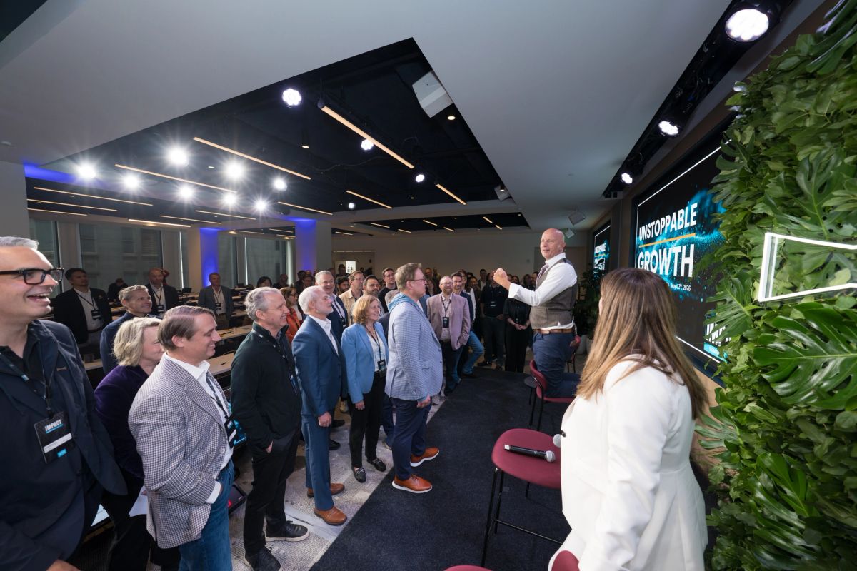Attendees listening to keynote speaker on stage at a conference at Convene SF