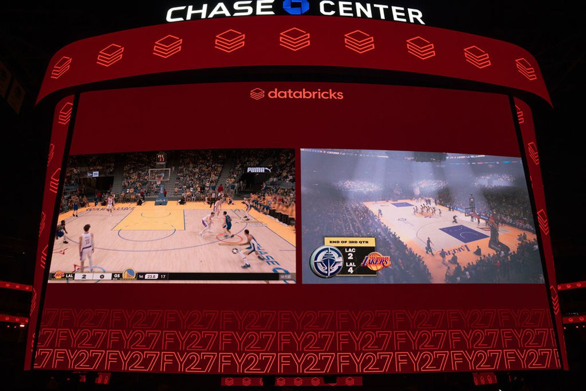 Large screens displaying basketball games at Chase Center with Databricks branding visible on overhead display