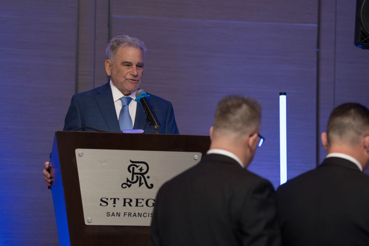 Speaker at podium addresses formal audience at St. Regis San Francisco event