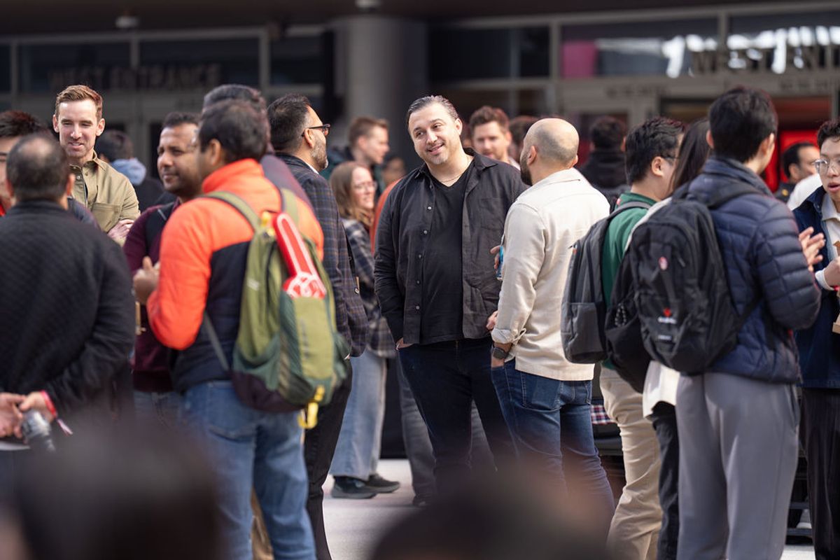 Conference attendees networking and conversing in groups at an indoor event venue