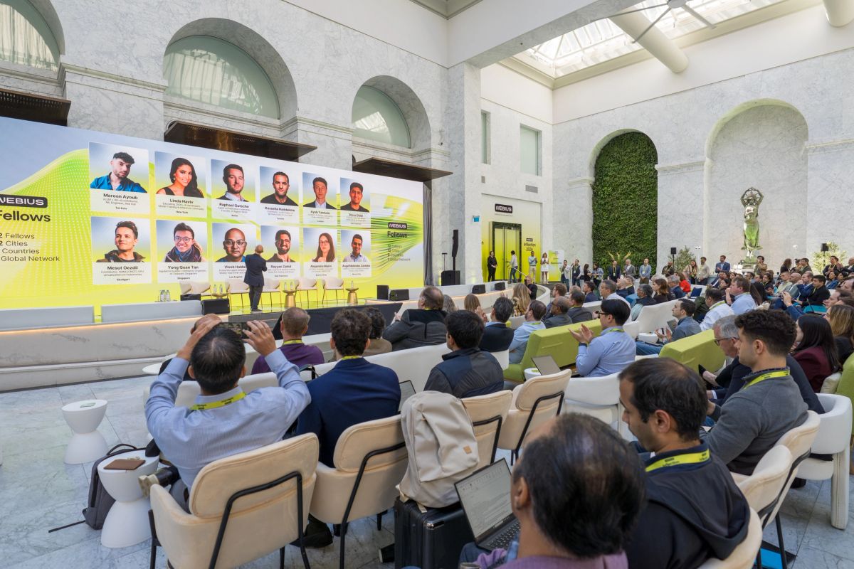 Nebius Fellows event at The Conservatory: attendees seated facing a large screen displaying fellow portraits.