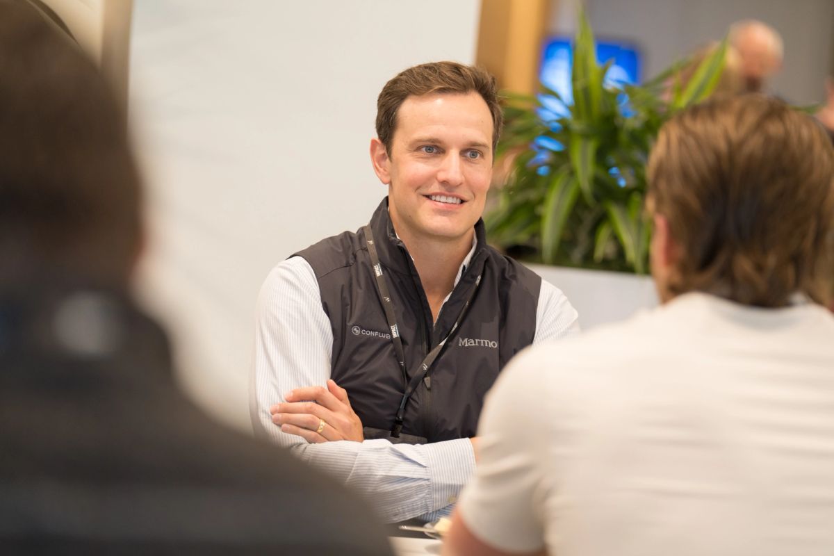 Event attendee smiling during a candid conversation at Conference.