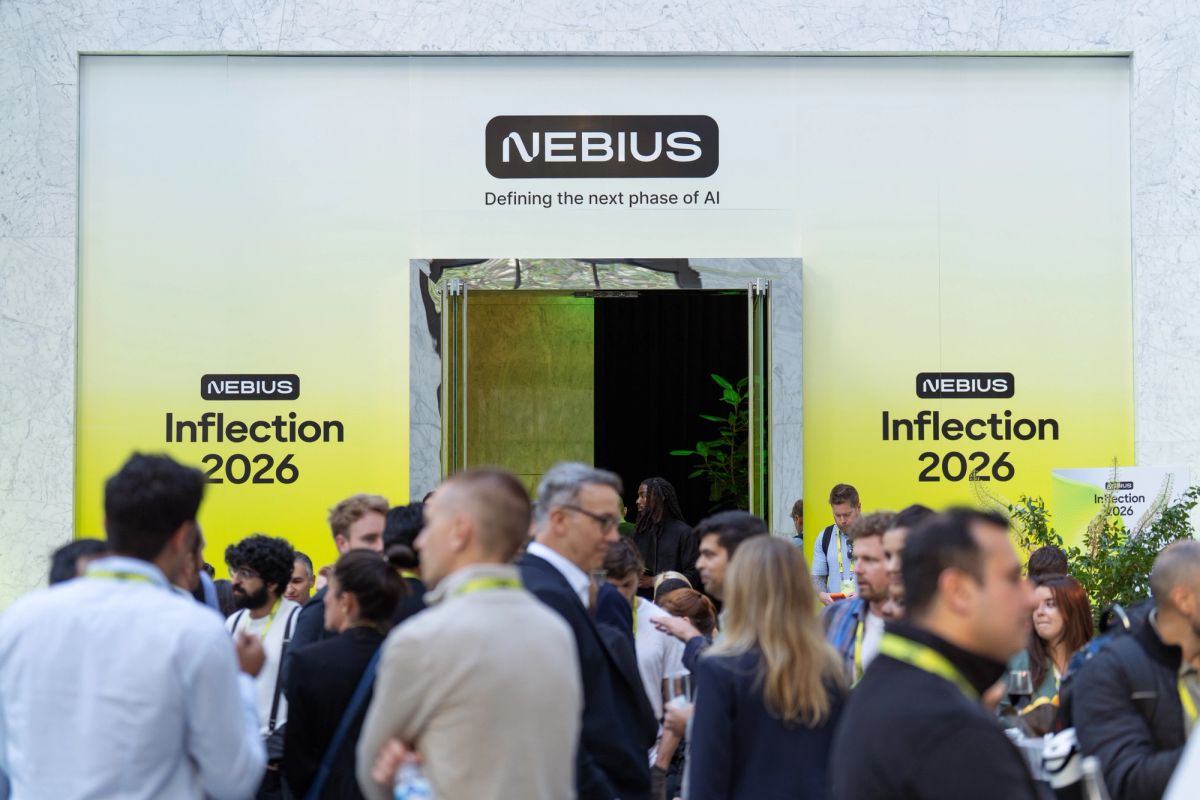 Attendees networking outside Nebius Inflection 2026 AI conference entrance.