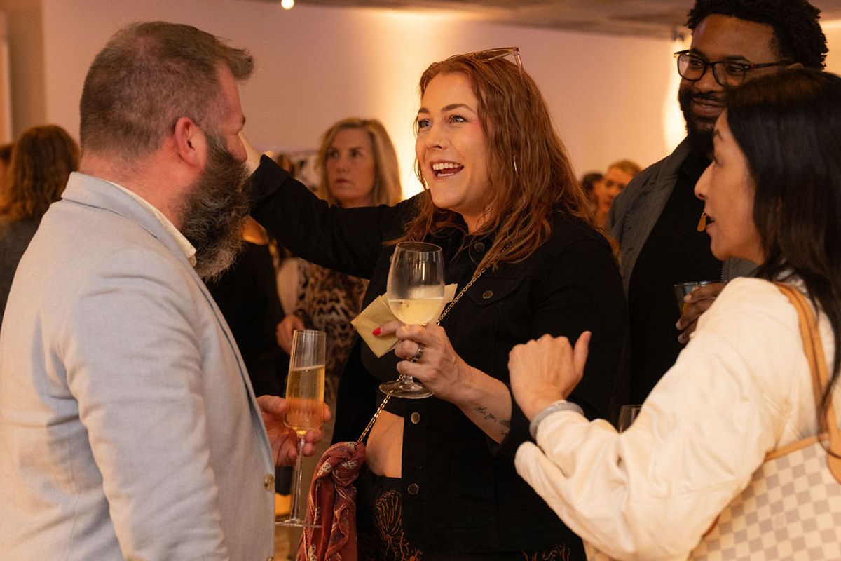 Business professionals networking and socializing with drinks at an indoor reception event