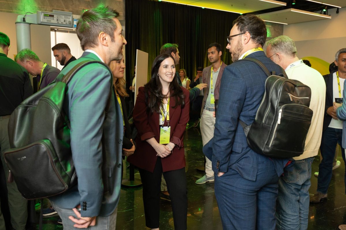 Attendees networking and conversing at a professional conference event.