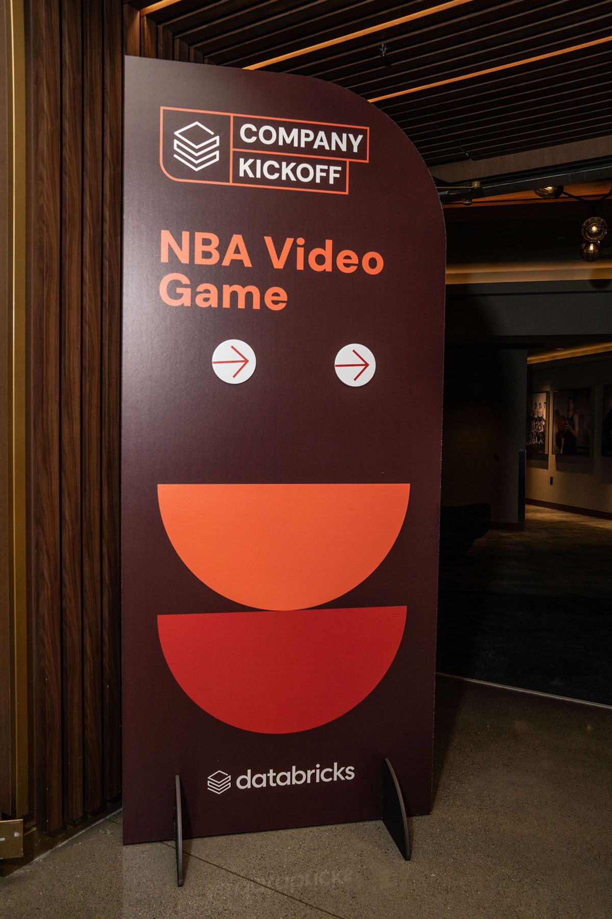 Large display banner for "NBA Video Game" company kickoff event by Databricks in modern conference venue