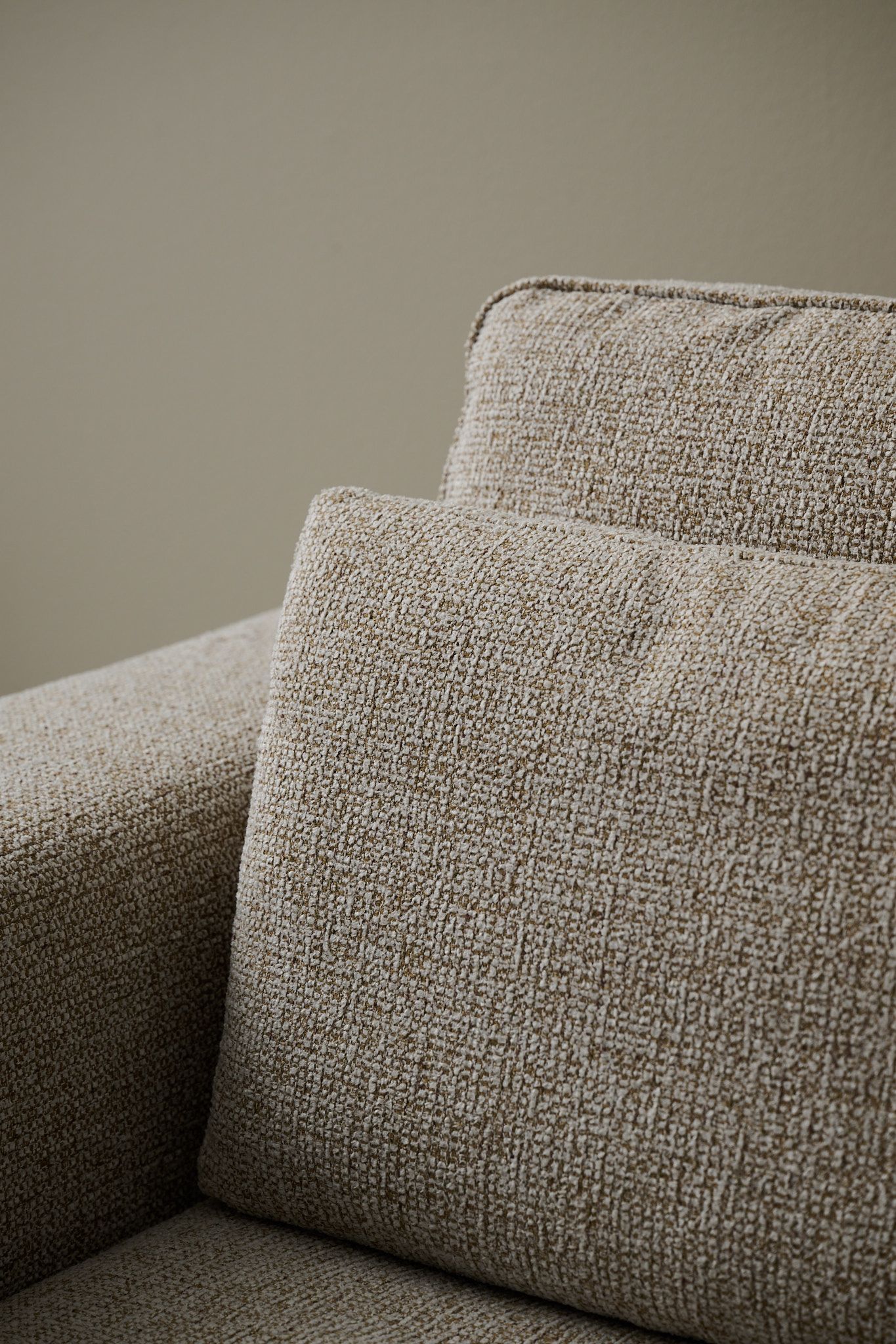 Close-up of light brown woven sofa fabric.