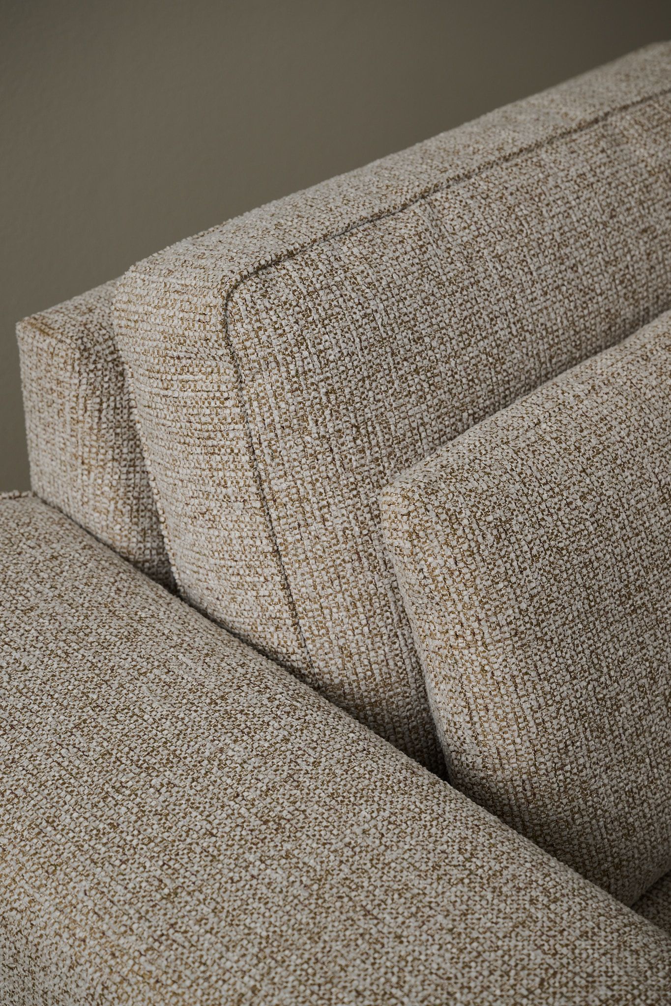 Close-up of beige textured sofa fabric.