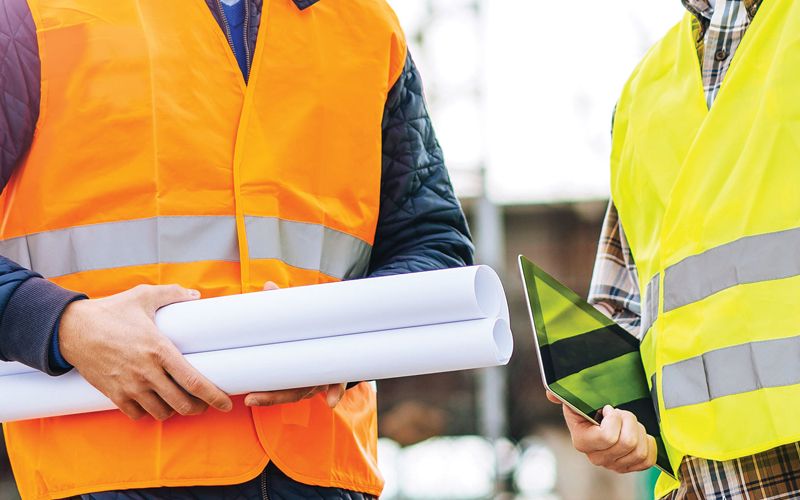 Construction engineering reps holding plans 