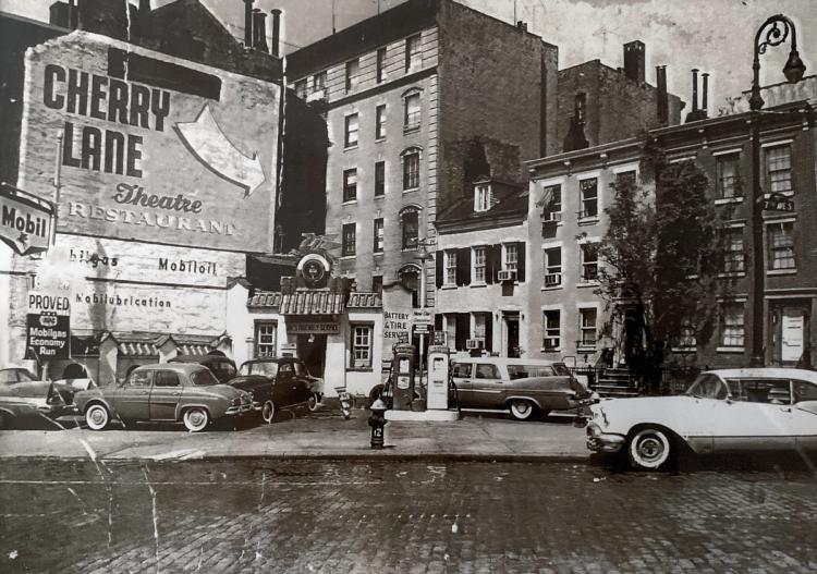 An older black-and-white photo of the square nearby. Cars in the foreground frame a giant mural with an arrow pointing to Cherry Lane. 