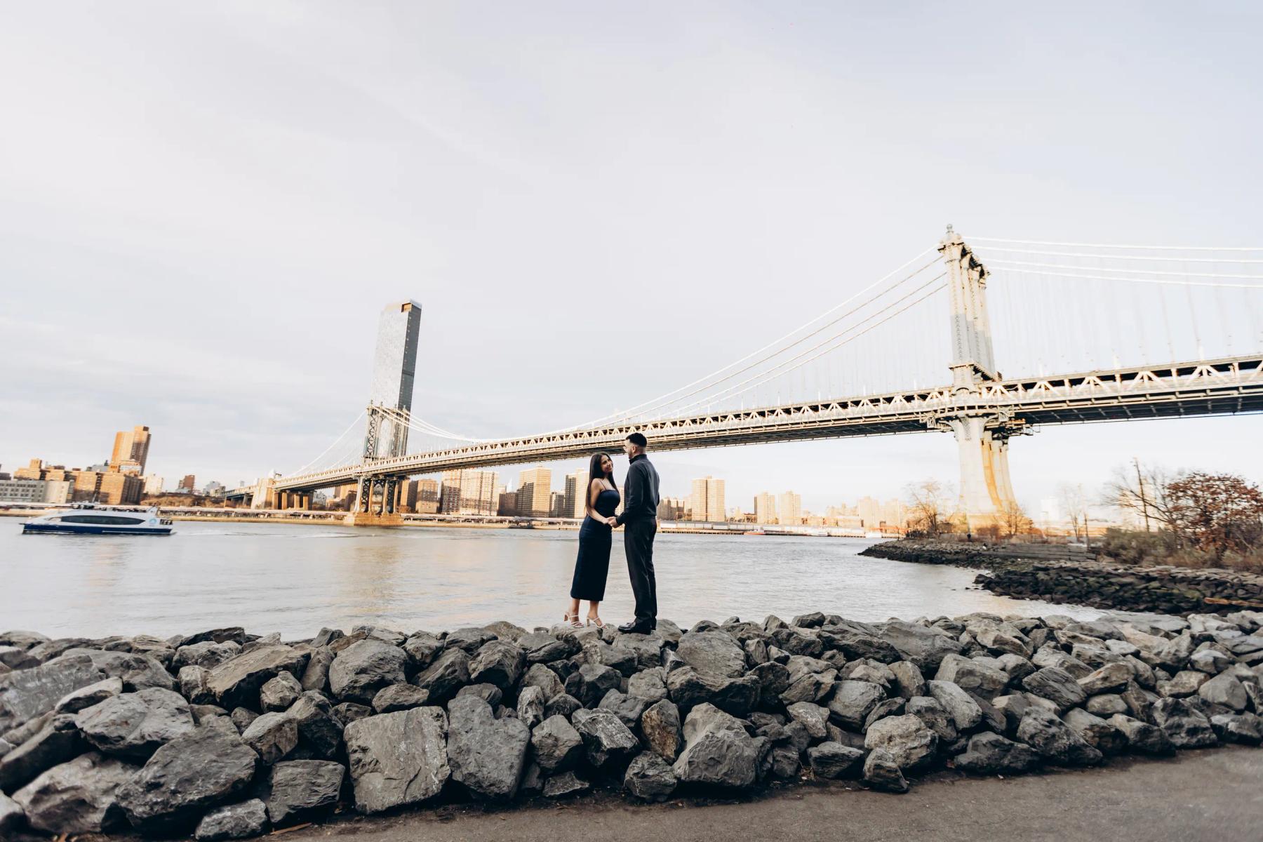 Couple standing near the bridge at golden hour.