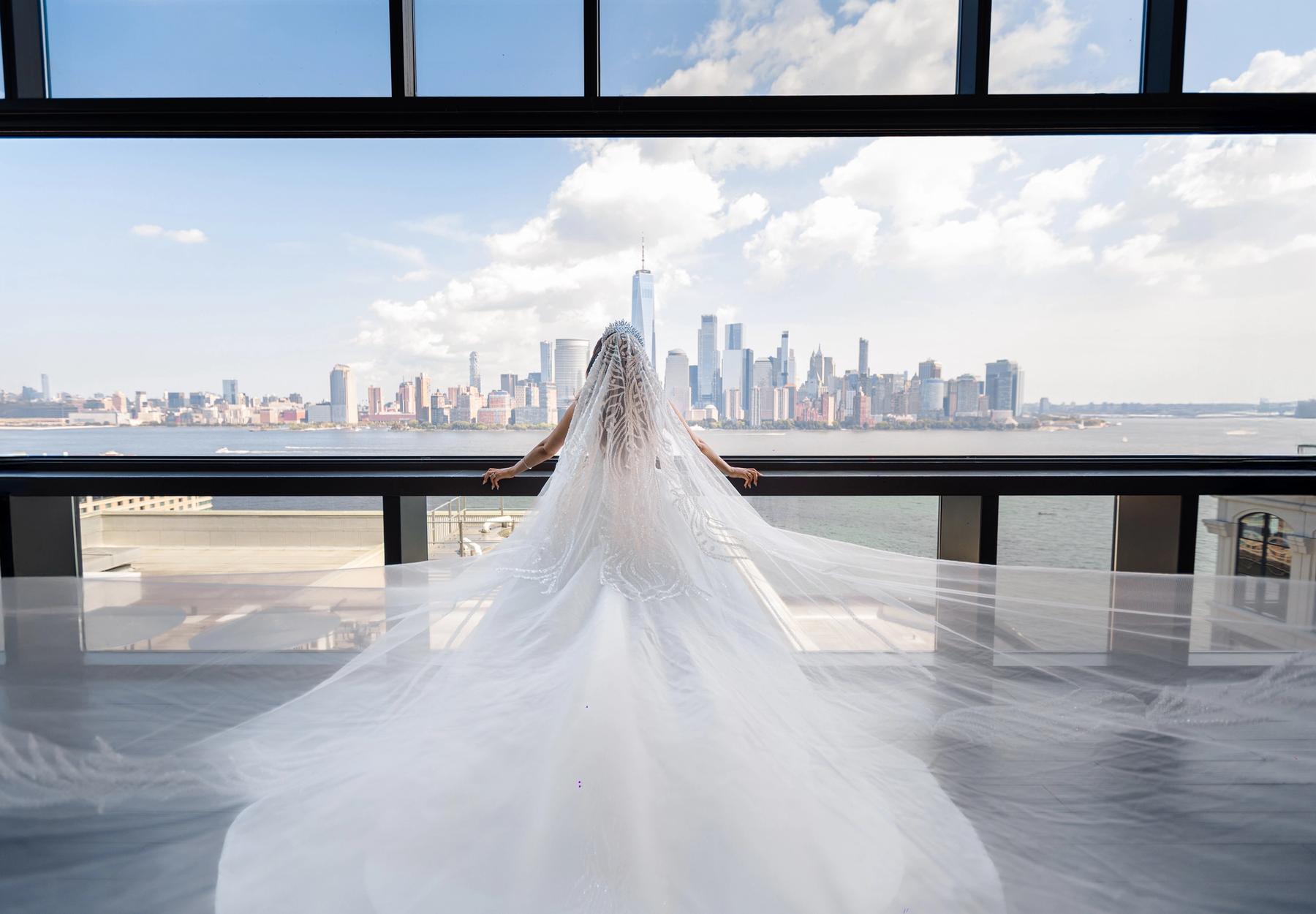 Bride and groom on a ballroom dance floor framed by florals.