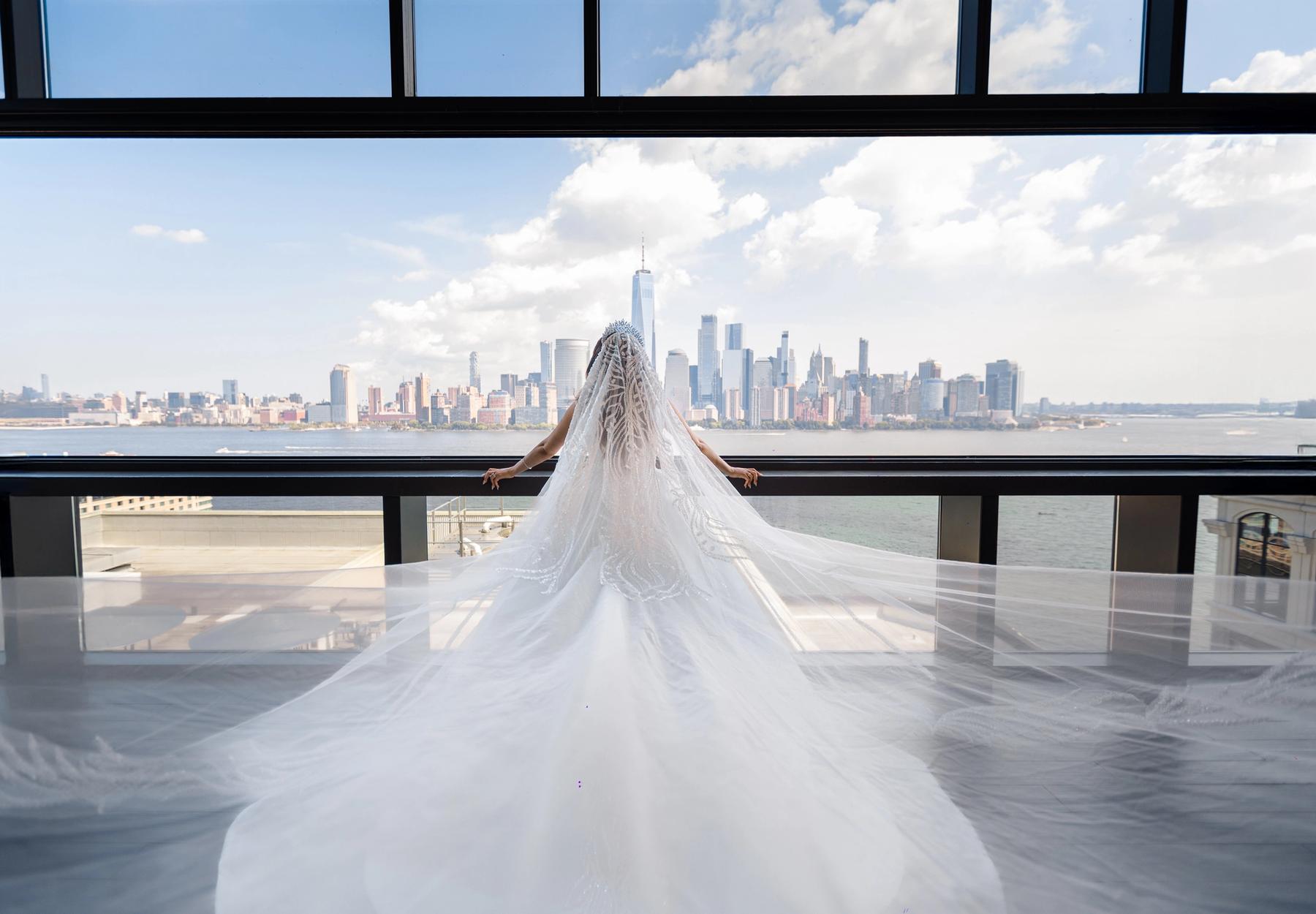Bride and groom on a ballroom dance floor framed by florals.