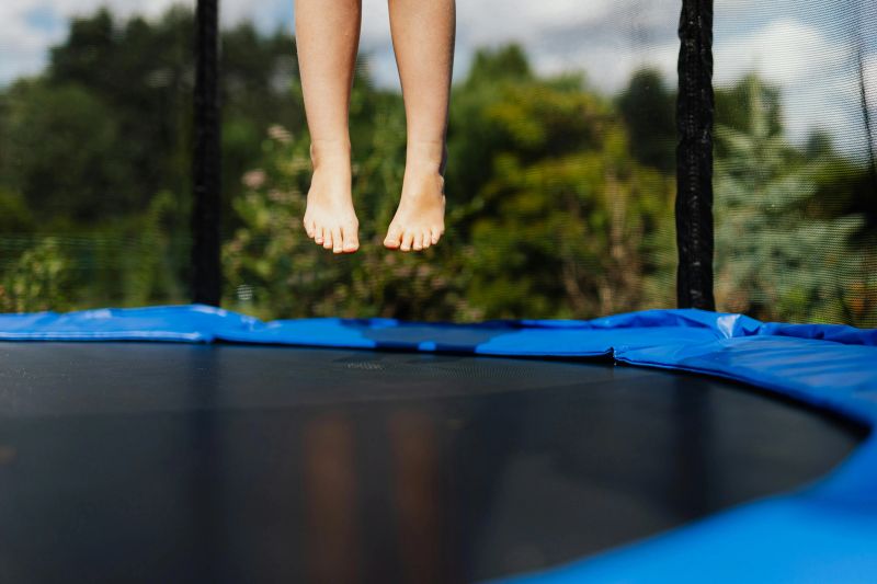 feet jumping on a trampoline