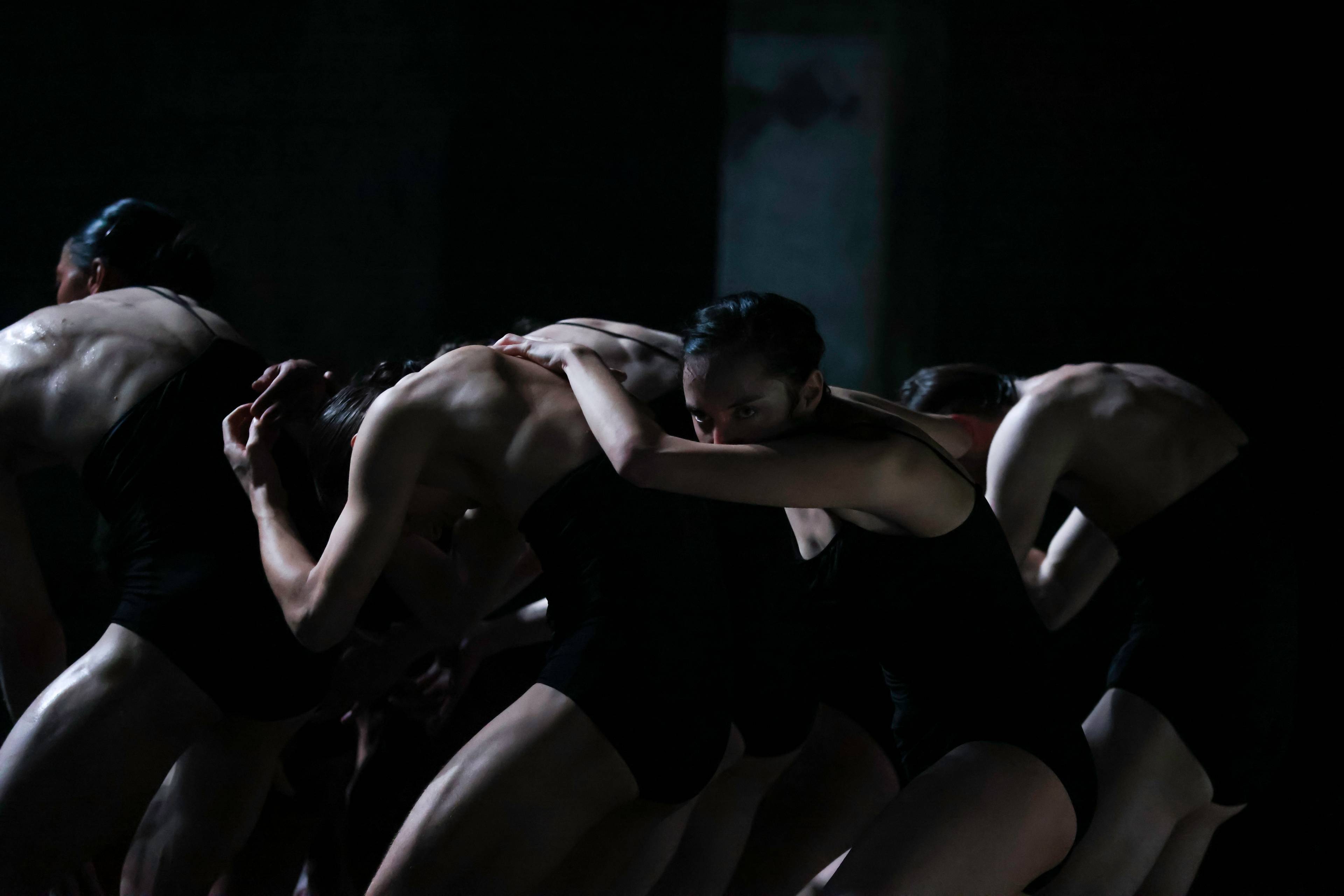 Four shadowed dancers from the dance company L-E-V perform in This Is Not a Love Show at Kraftwerk Berlin.