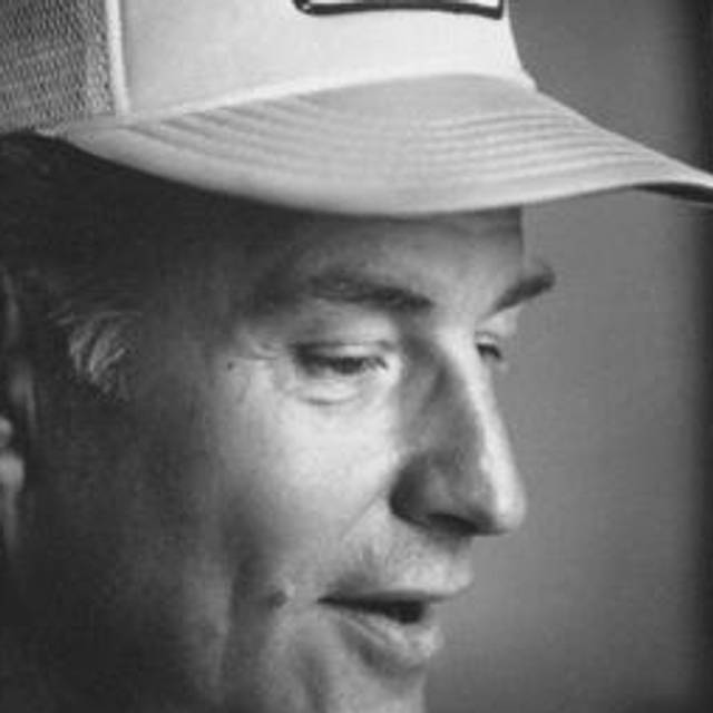 Close-up right profile portrait of artist Robert Irwin in a Hollywood Park trucker hat.