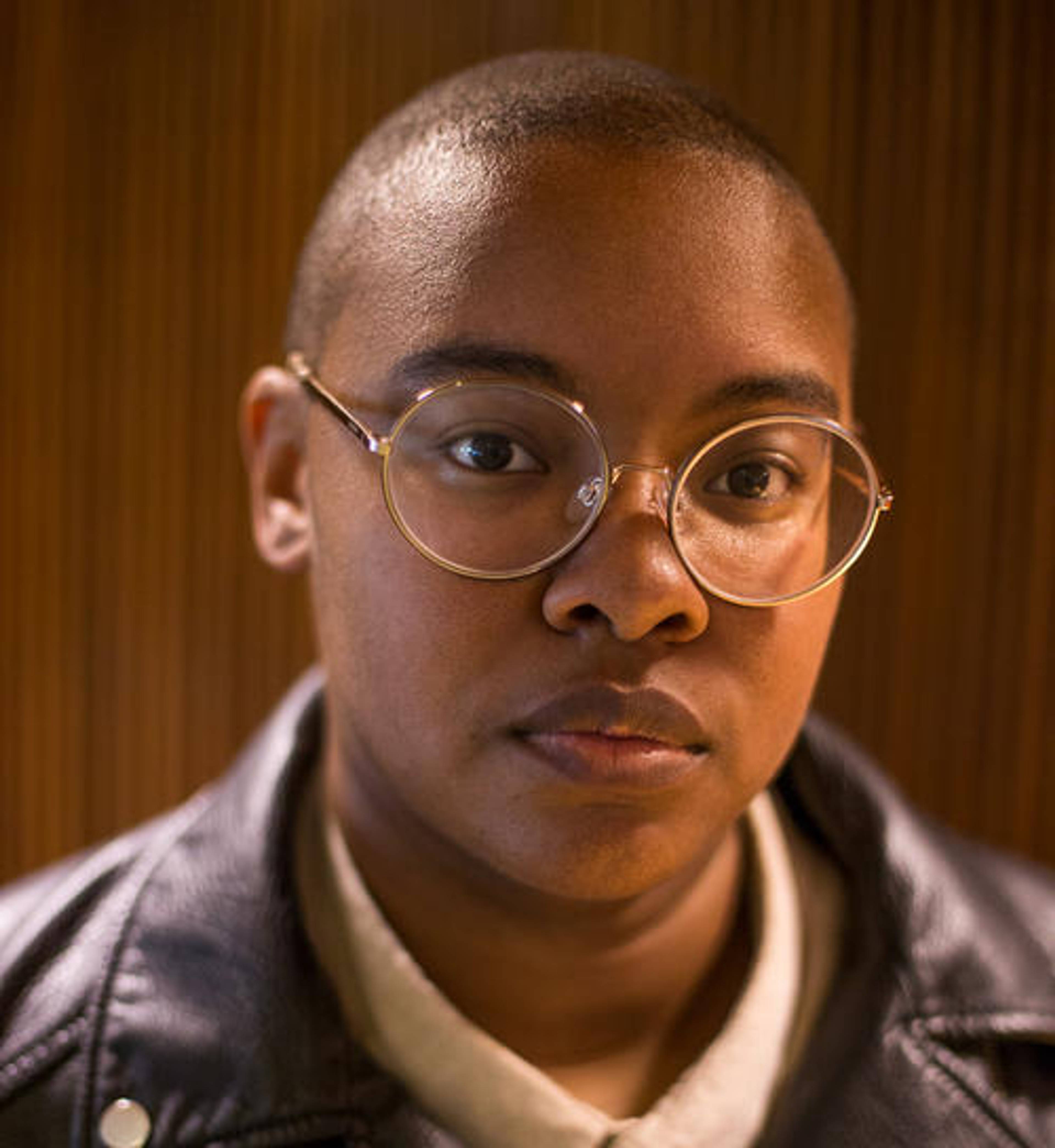 Portrait of a person wearing glasses and a biker jacket