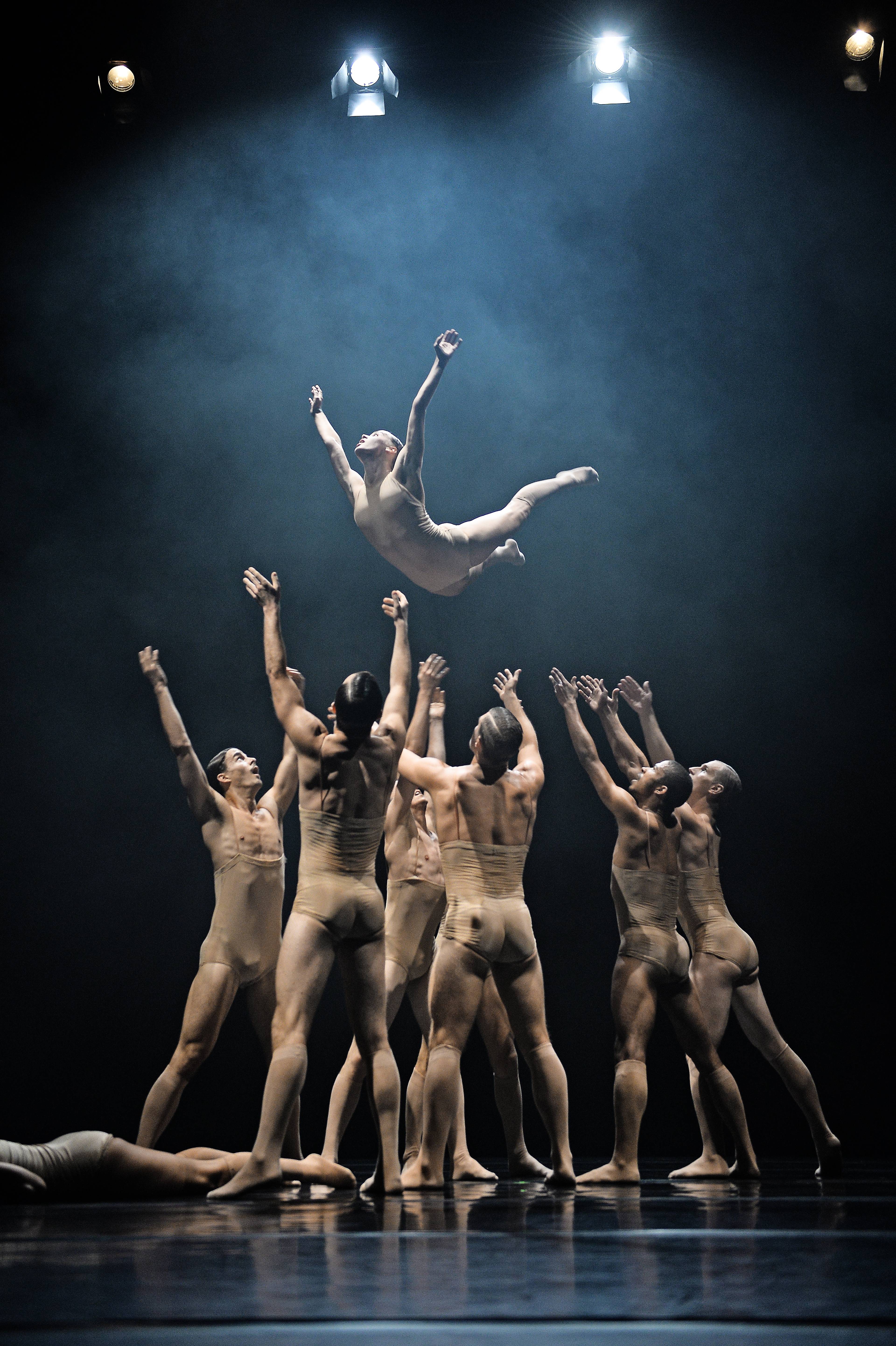 Action shot of a dancer thrown into the air by a group of fellow dancers from the dance company tanzmainz.