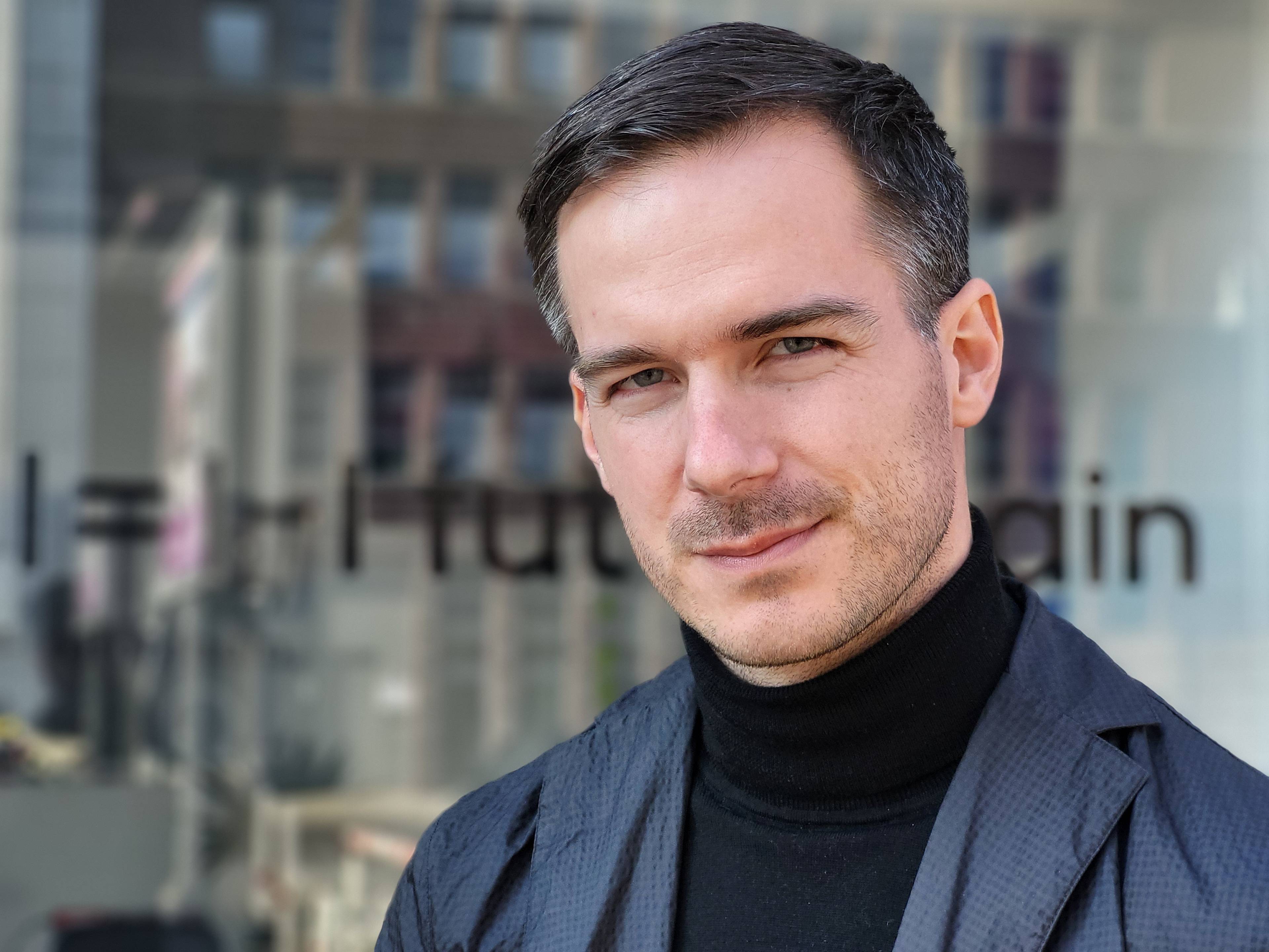 Portrait of Matyas Kovacs standing in front of the offices of Berlin-based creative agency futurehain.