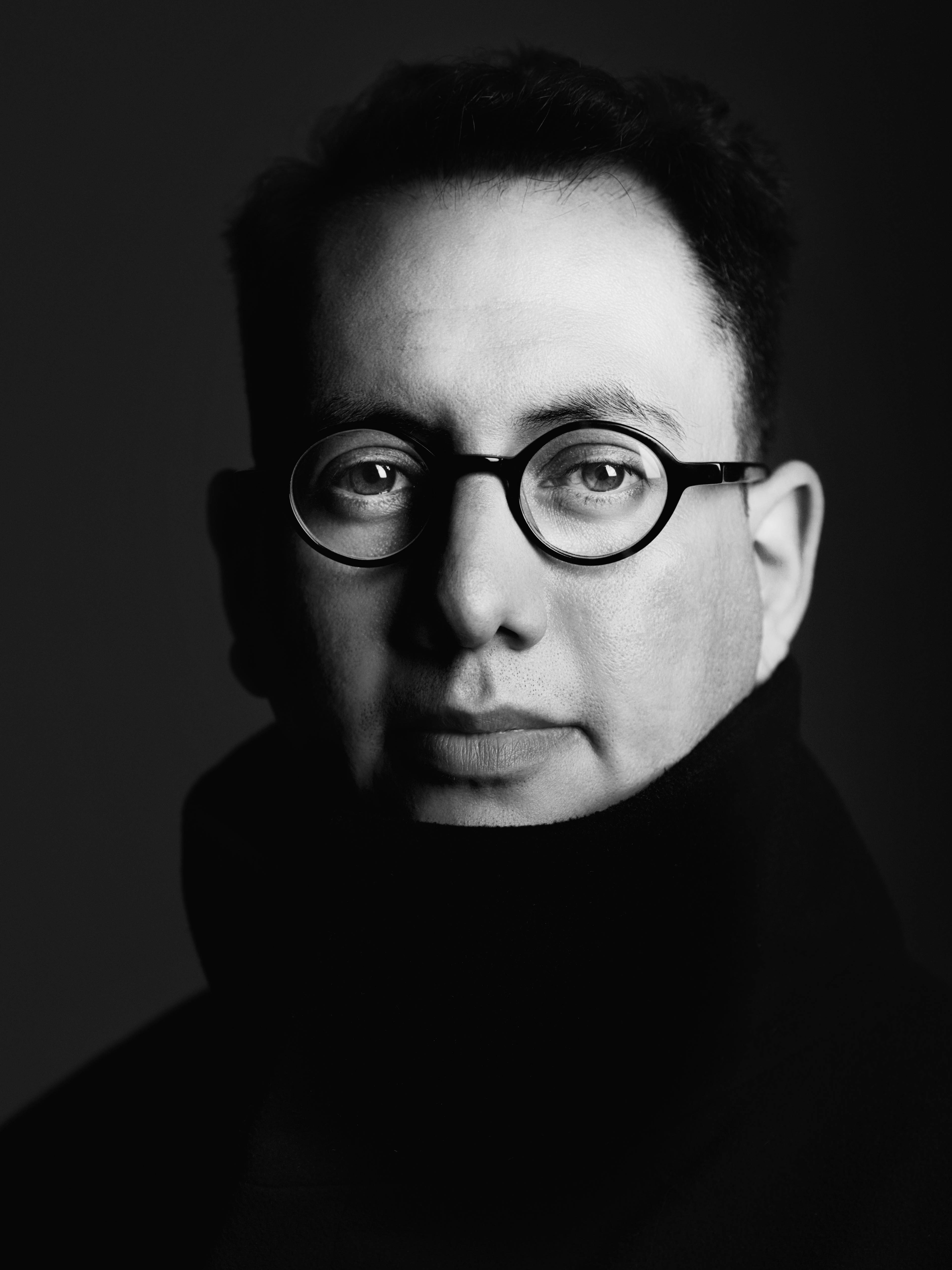 Close-up black-and-white portrait of media artist Refik Anadol.