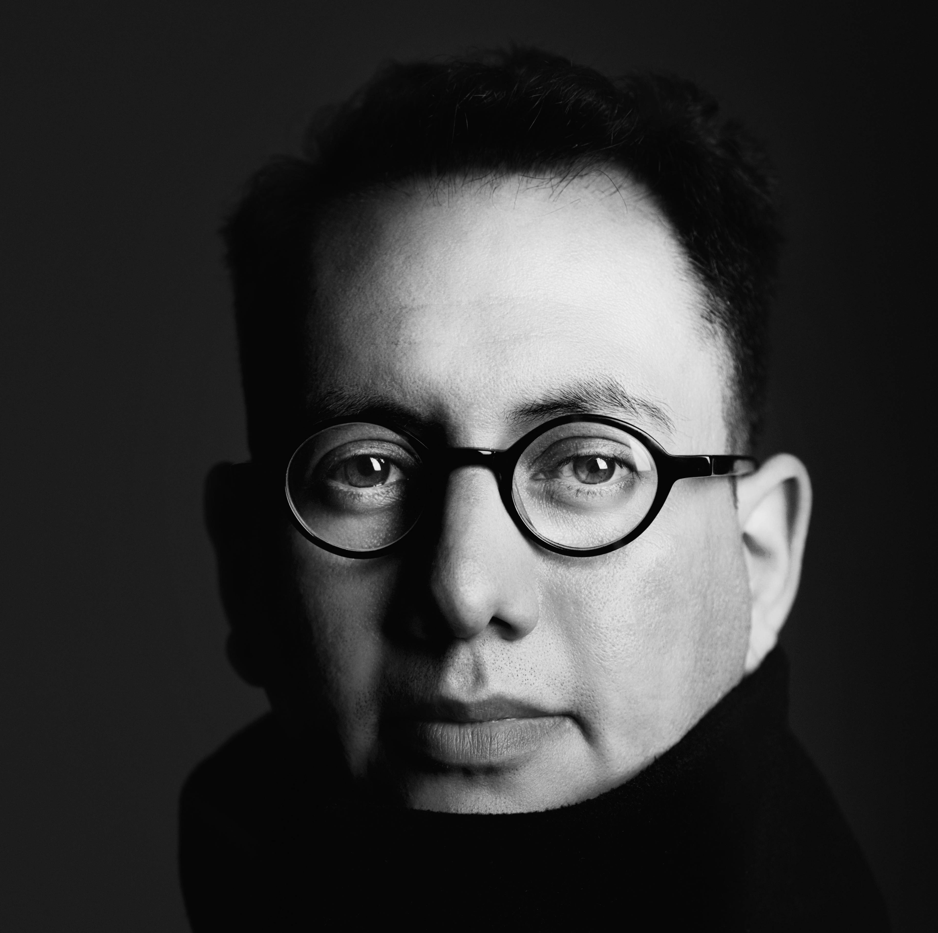 Close-up black-and-white portrait of media artist Refik Anadol.