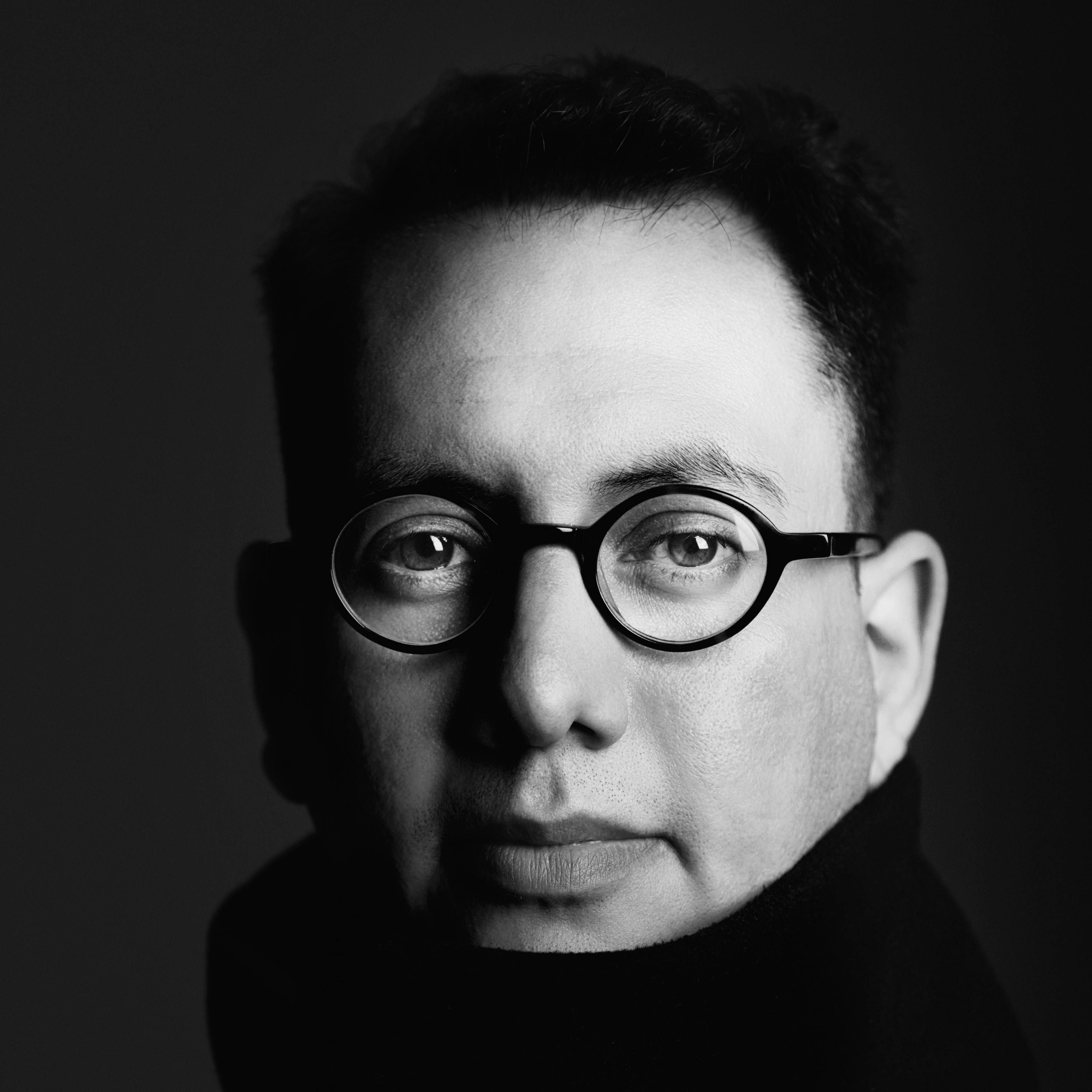 Close-up black-and-white portrait of media artist Refik Anadol.