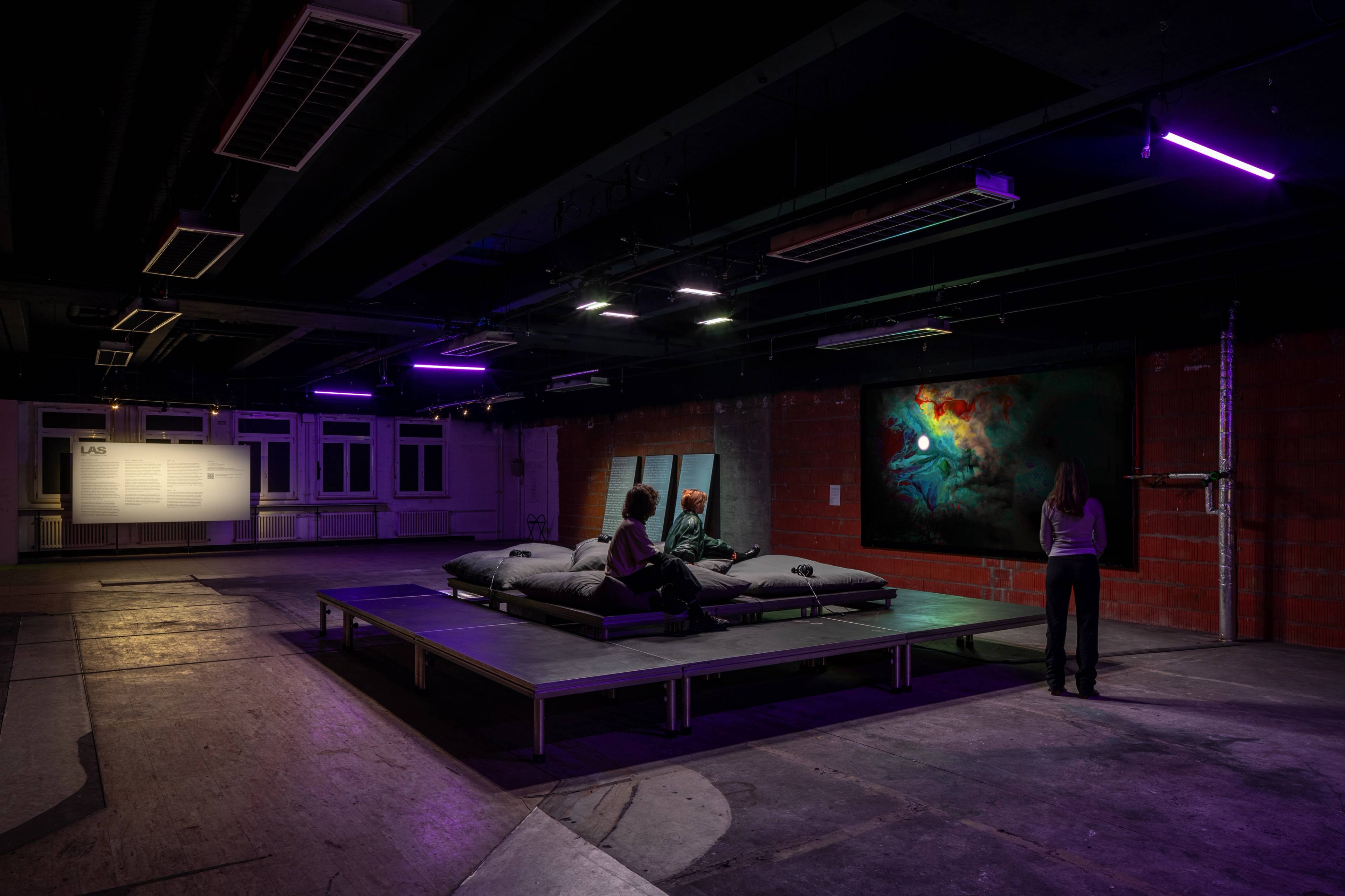 A DJ and rapper perform at a crowded indoor event, with the audience closely gathered around, enjoying the show.