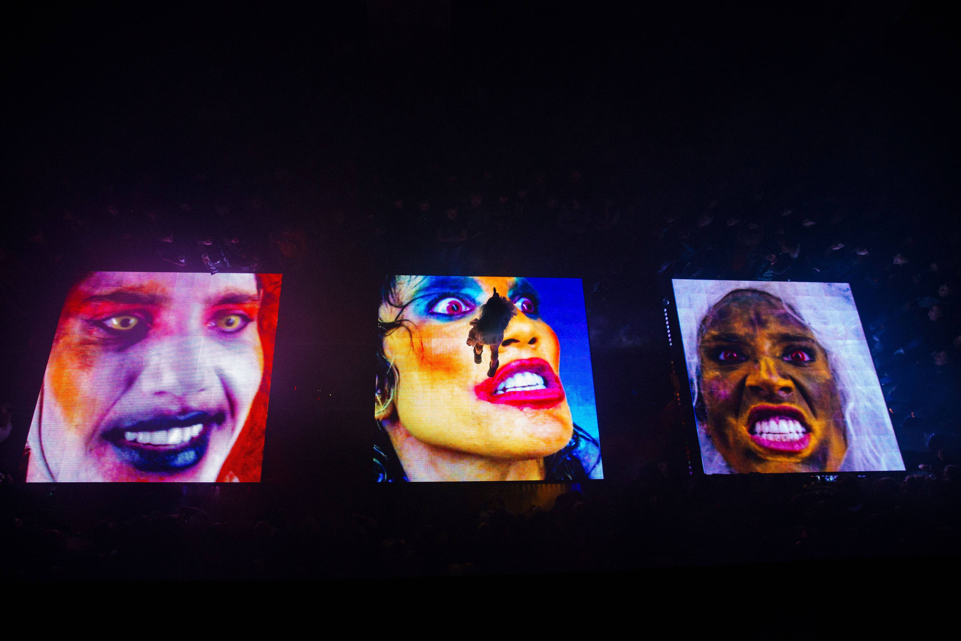 Three screens in a horizonal line, each showing a close-up of a color-altered face with teeth bared.