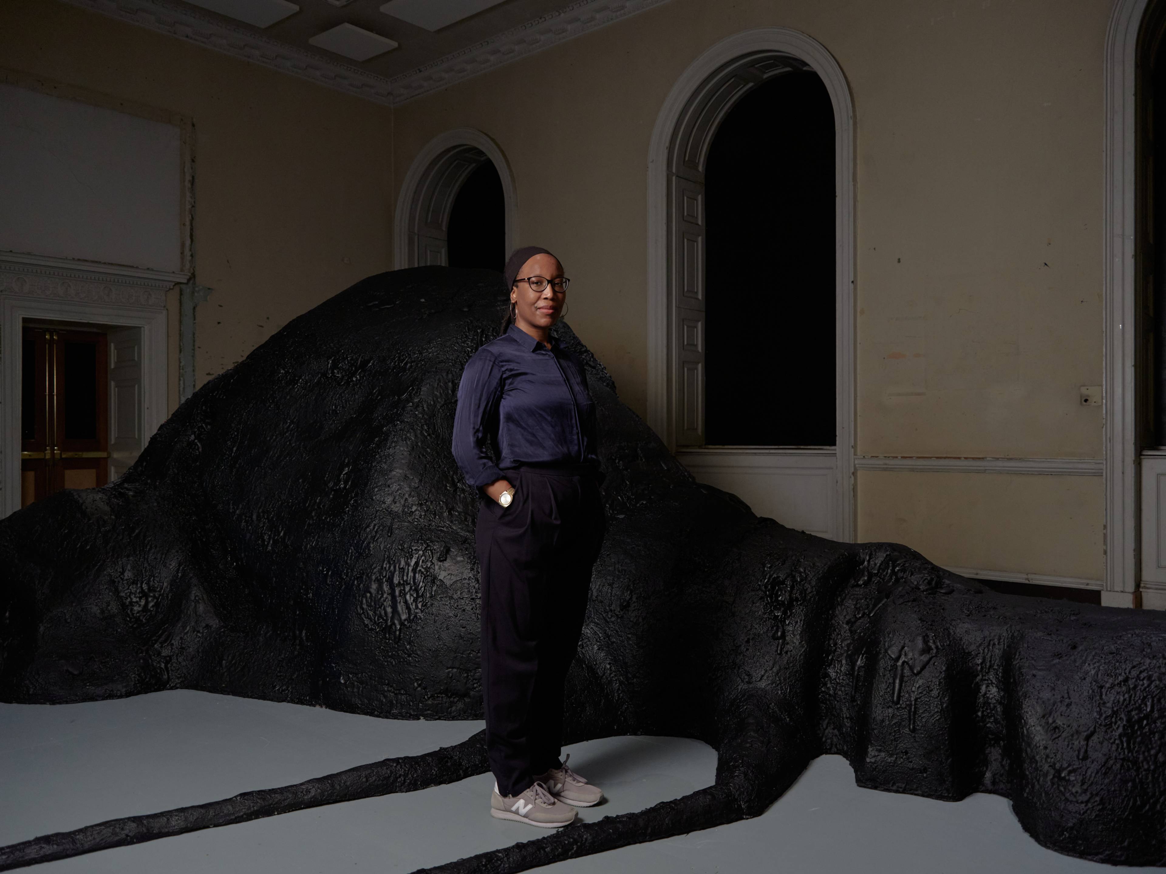 Portrait of a woman standing in front of a vast floor sculpture