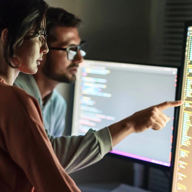 Developers inspect code while pair programming