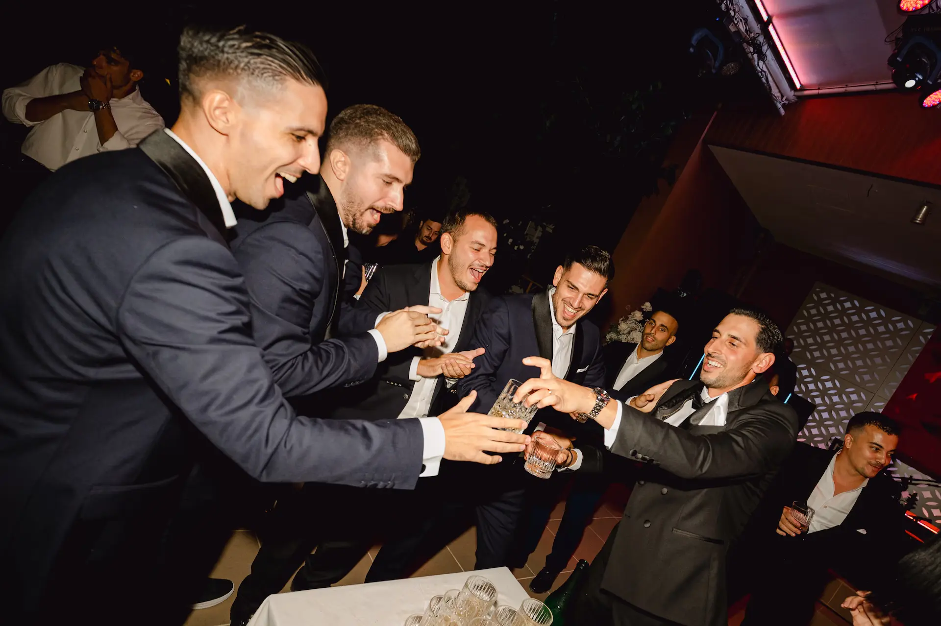groom offering drink to his friends