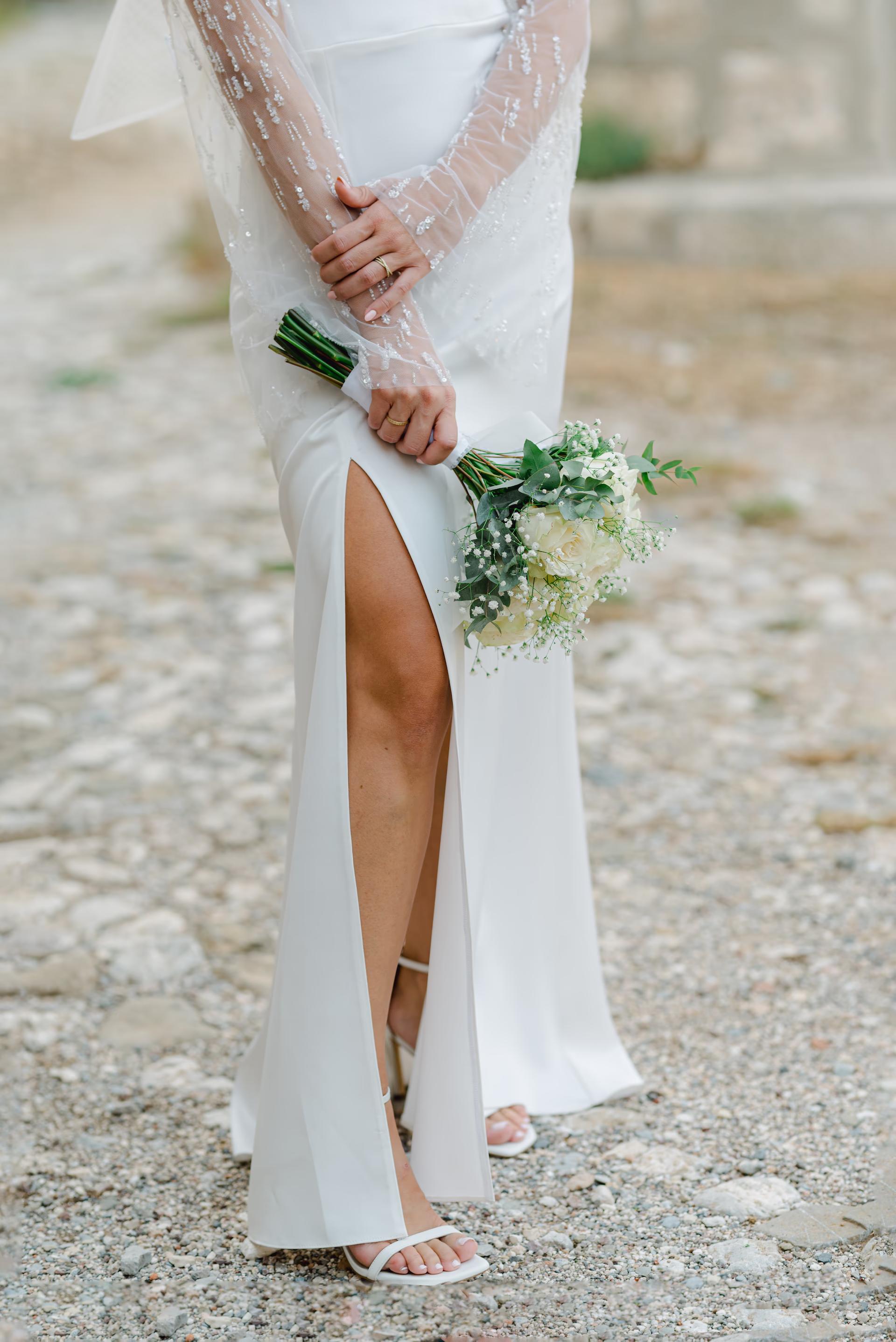 bride in wedding dress holding a bouquet of flowers
