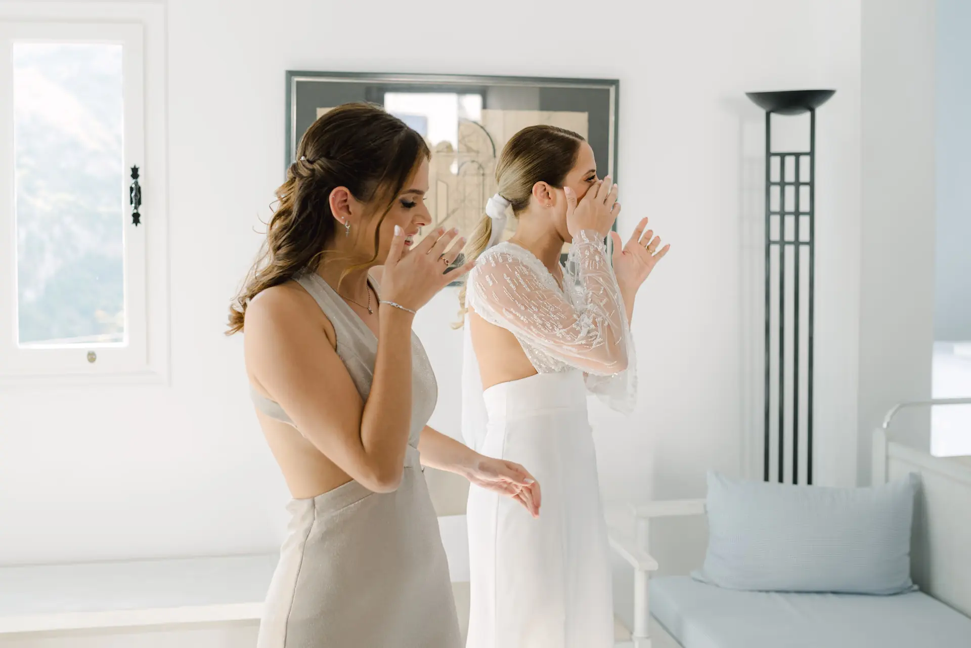 Emotional moment between bride and maid of honor during wedding preparations in Kythira.