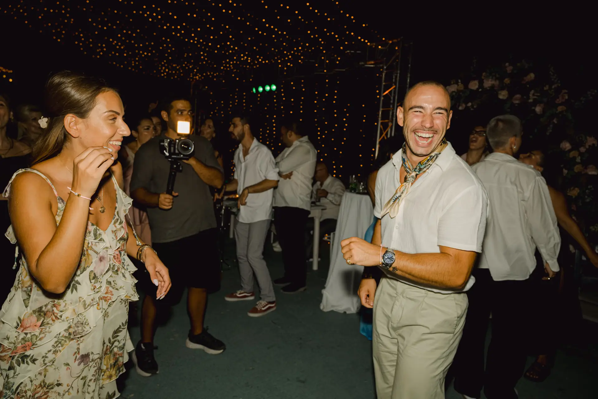 a man and woman laughing at the party