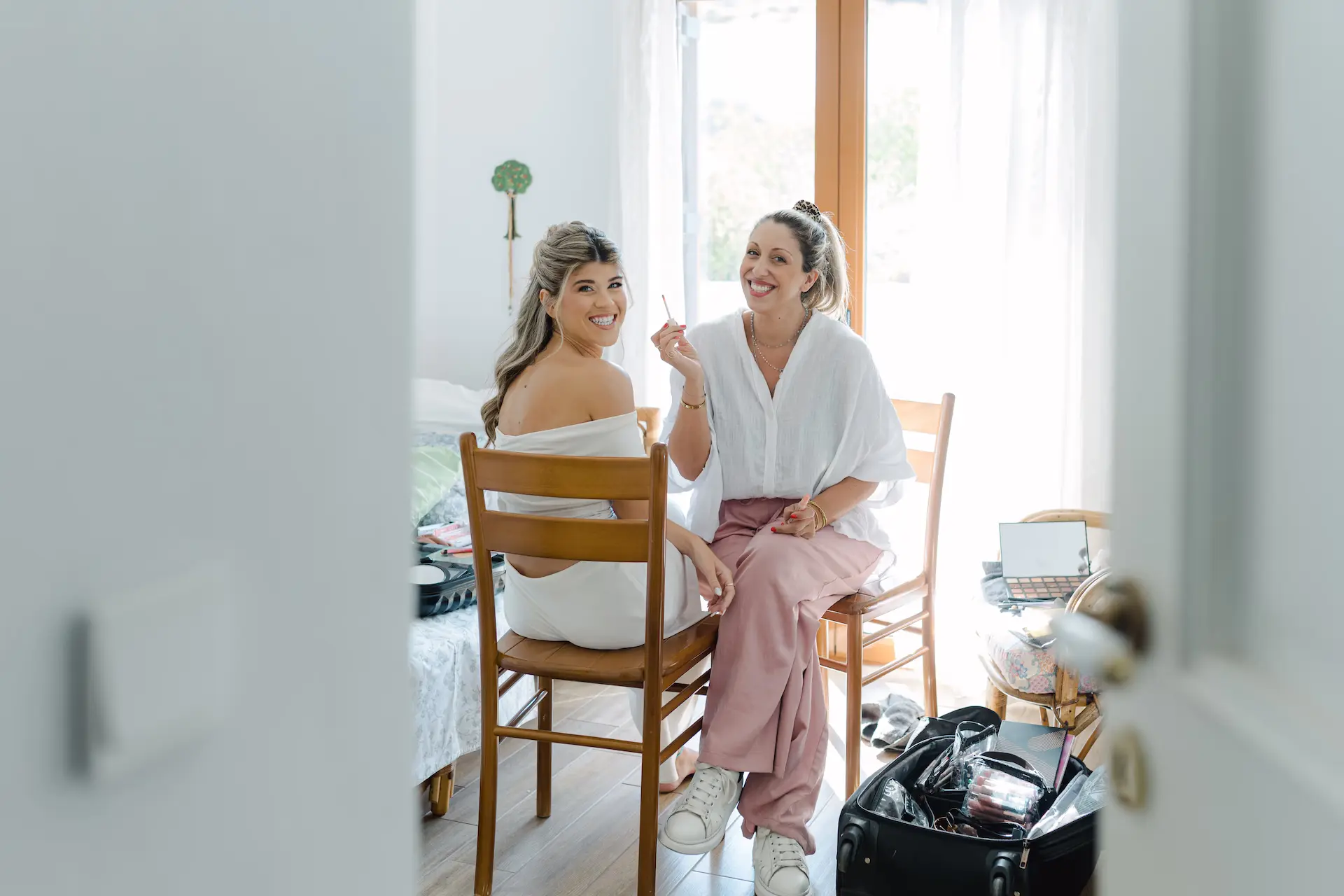 Candid shot of the bride’s final makeup touches during her wedding morning