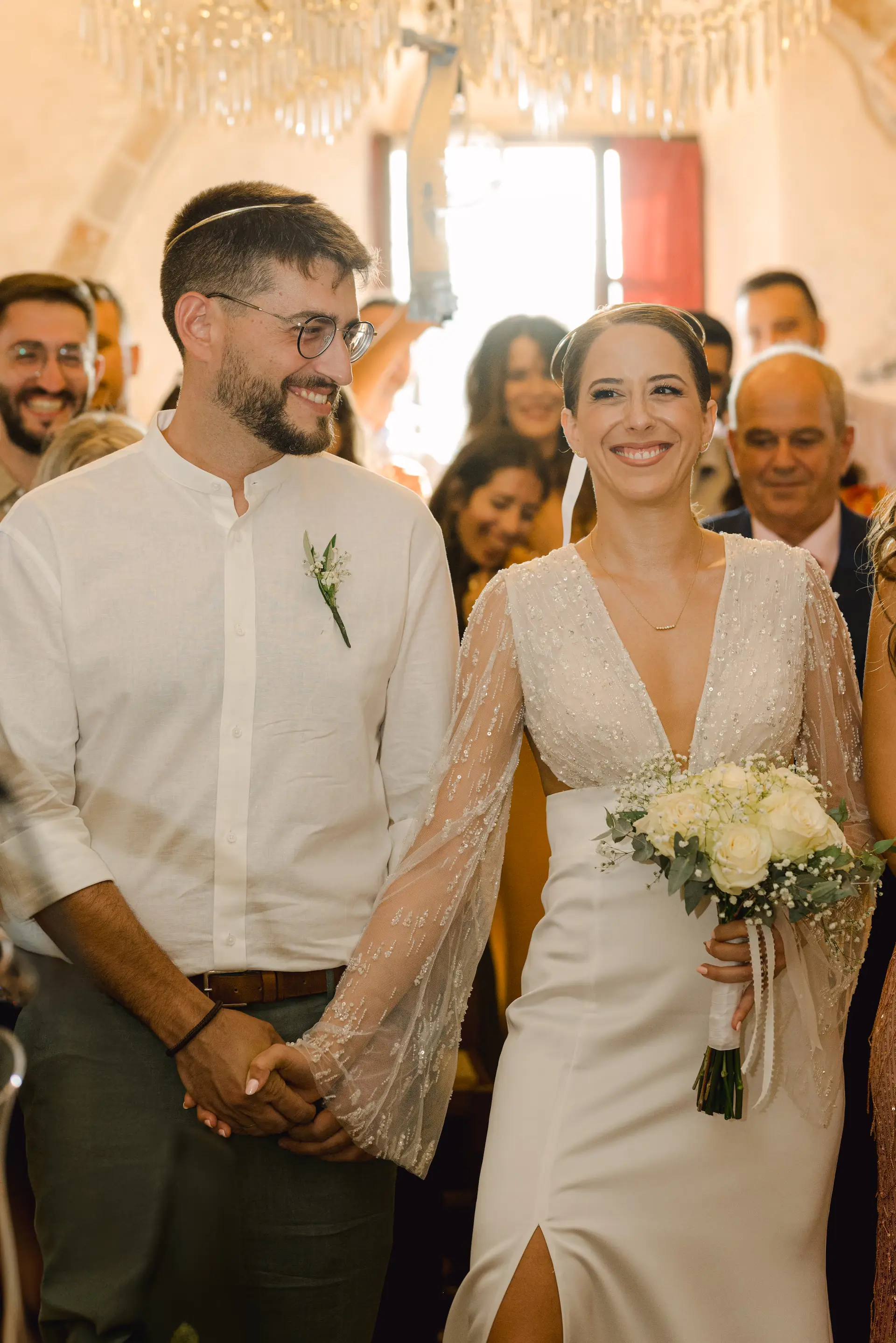 candid moment of bride and groom smiling during ceremony