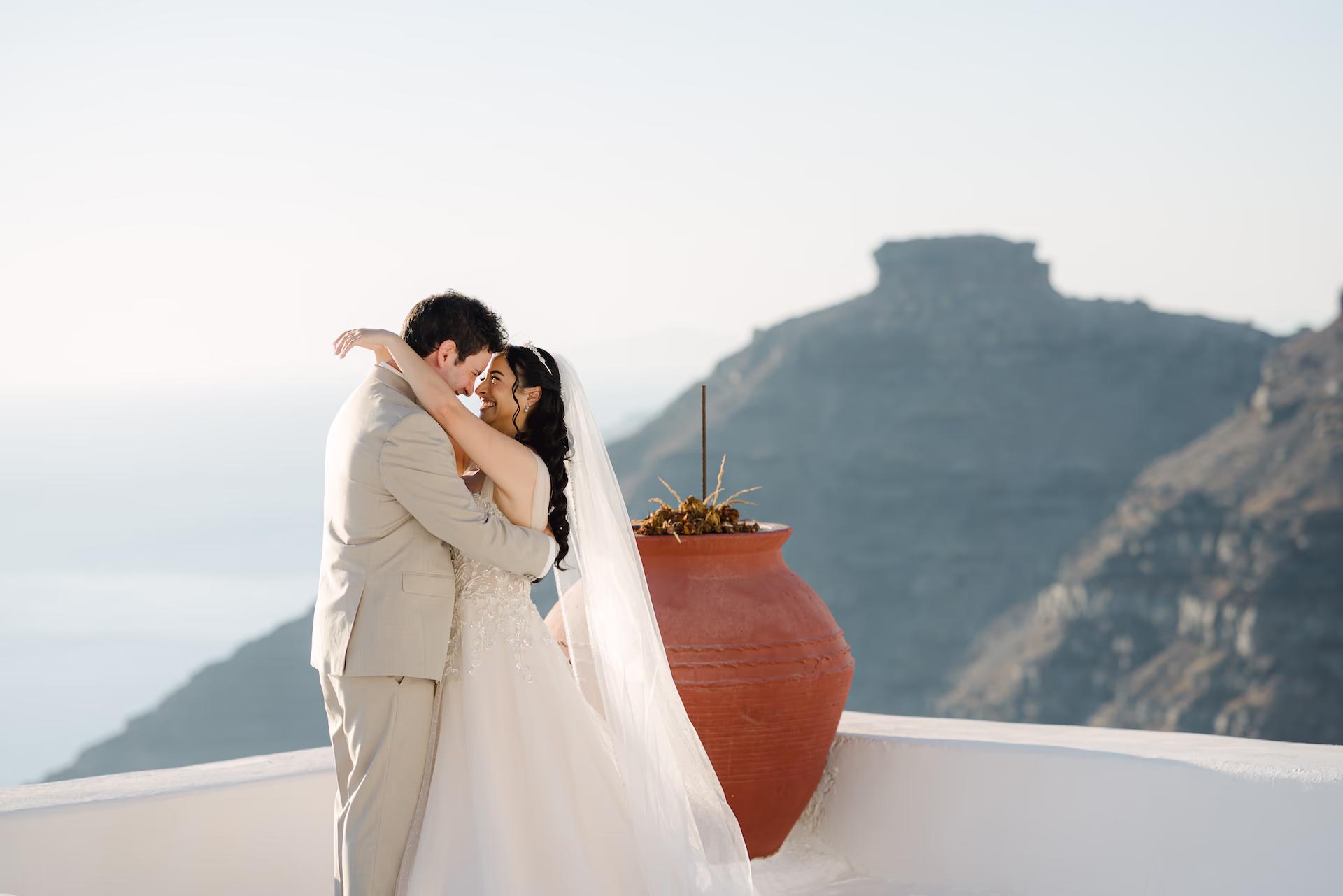 Emotional wedding couple hug in Santorini