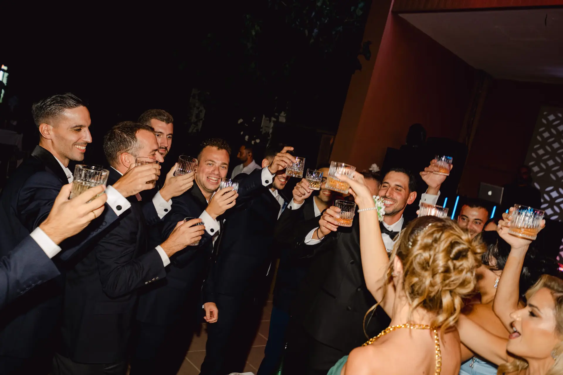 a group of people holding glasses