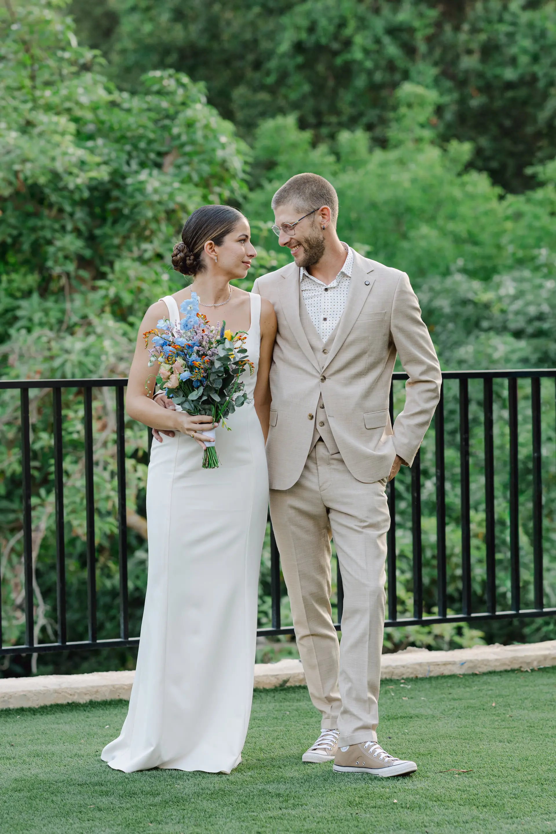 bride and groom standing next to each other during ceremony