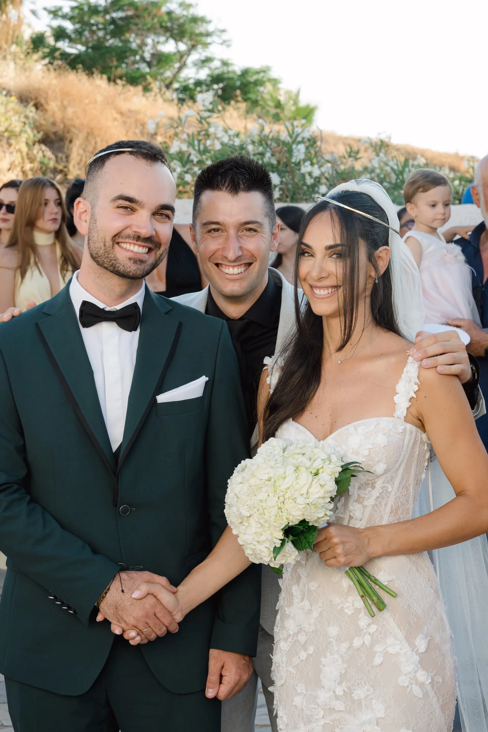 the couple with the best man in a funny moment during wedding ceremony