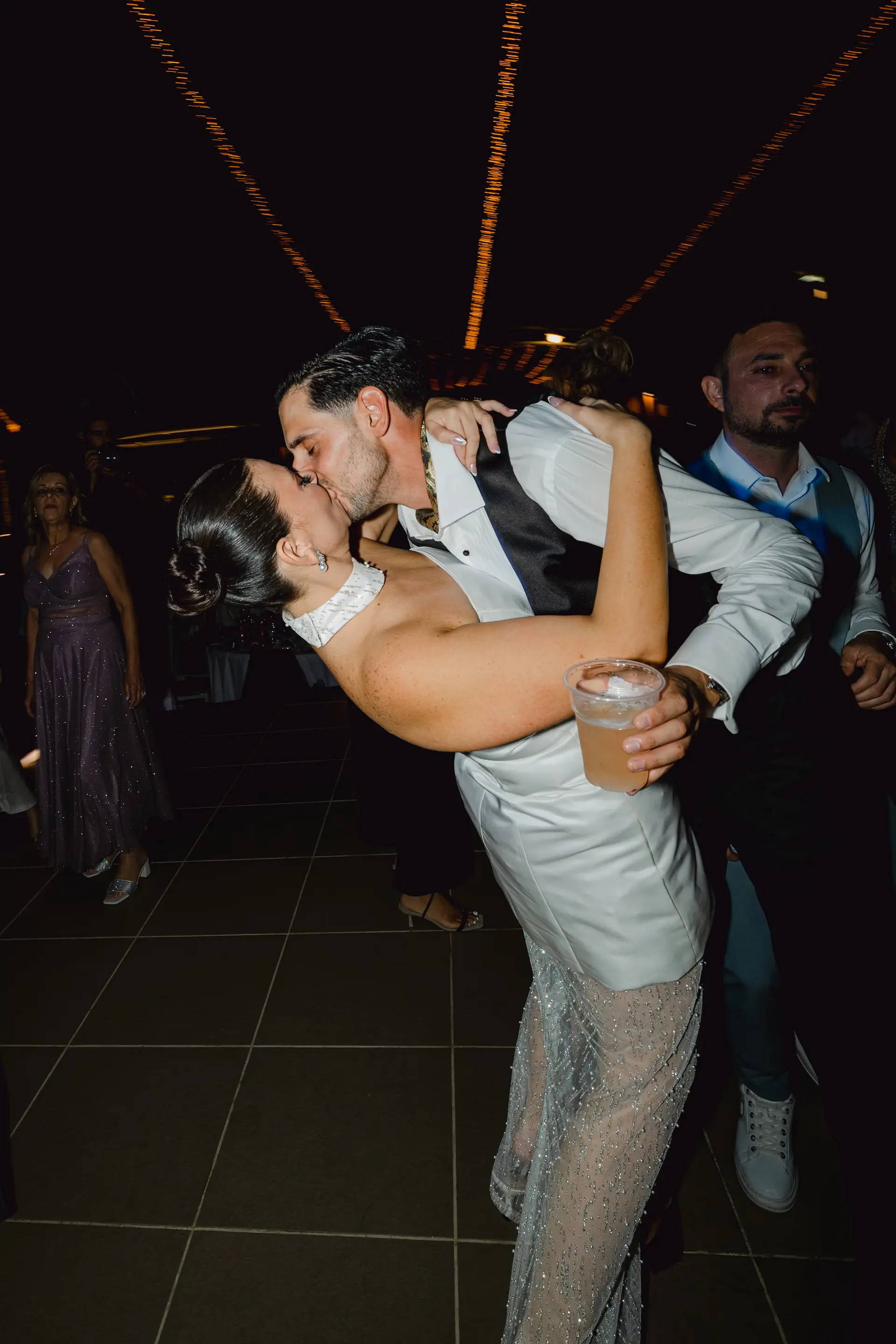 romantic kiss of the couple during party time