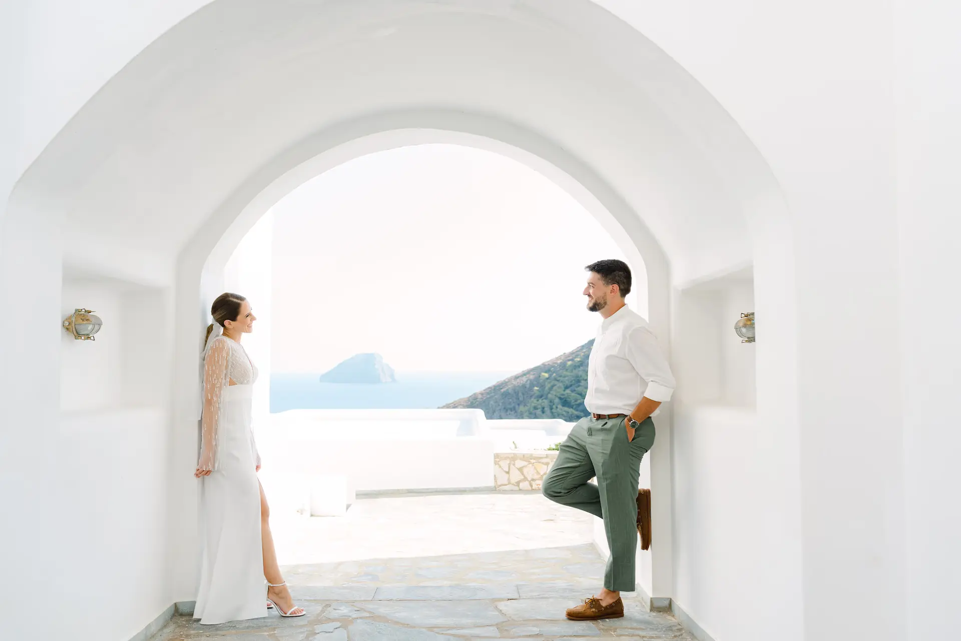 a man and woman standing in a doorway looking at each other