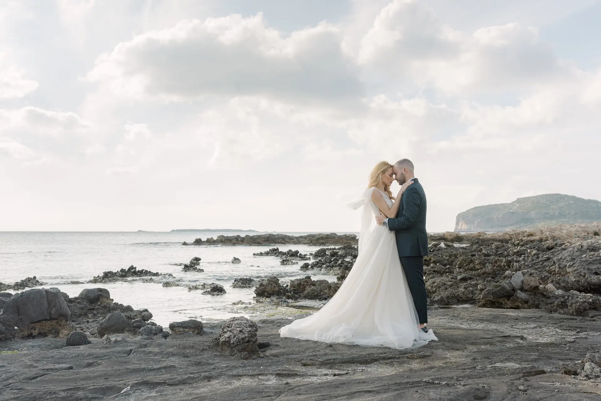 Emotional hug between the bride and groom on the shore of Falasarna beach.
