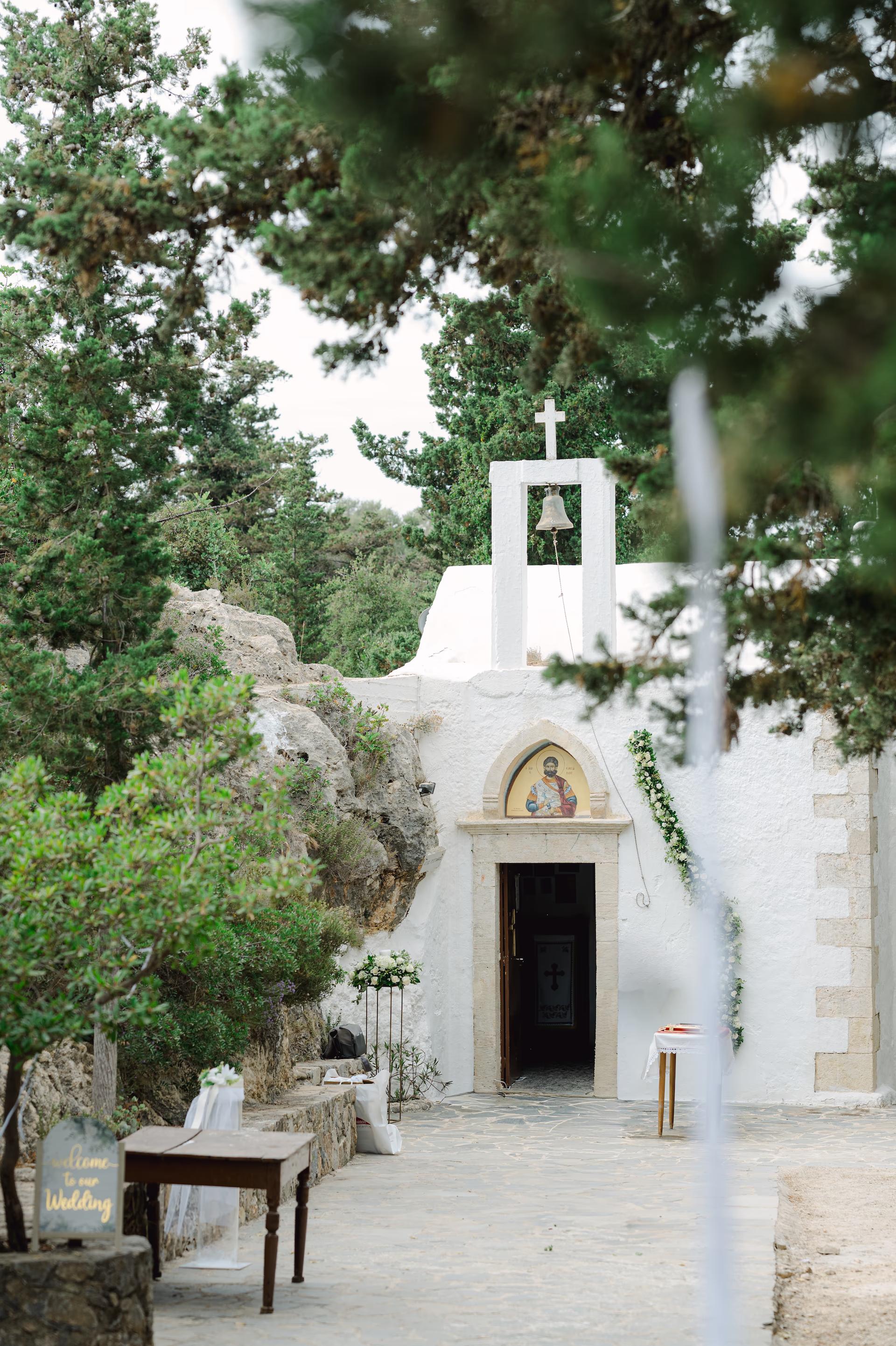 Scenic view of a Greek Orthodox church nestled in the rocky cliffs of Akrotiri, Crete.