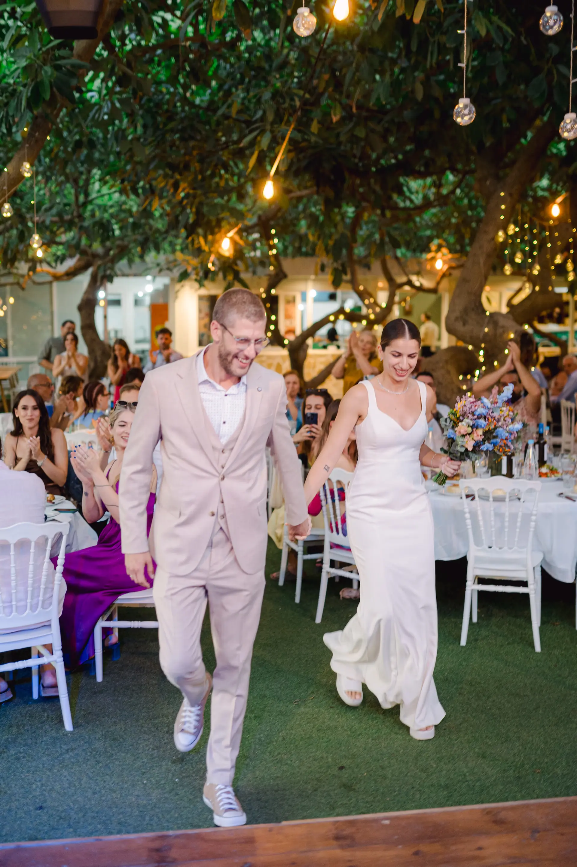 bride and groom make their entrance in wedding reception